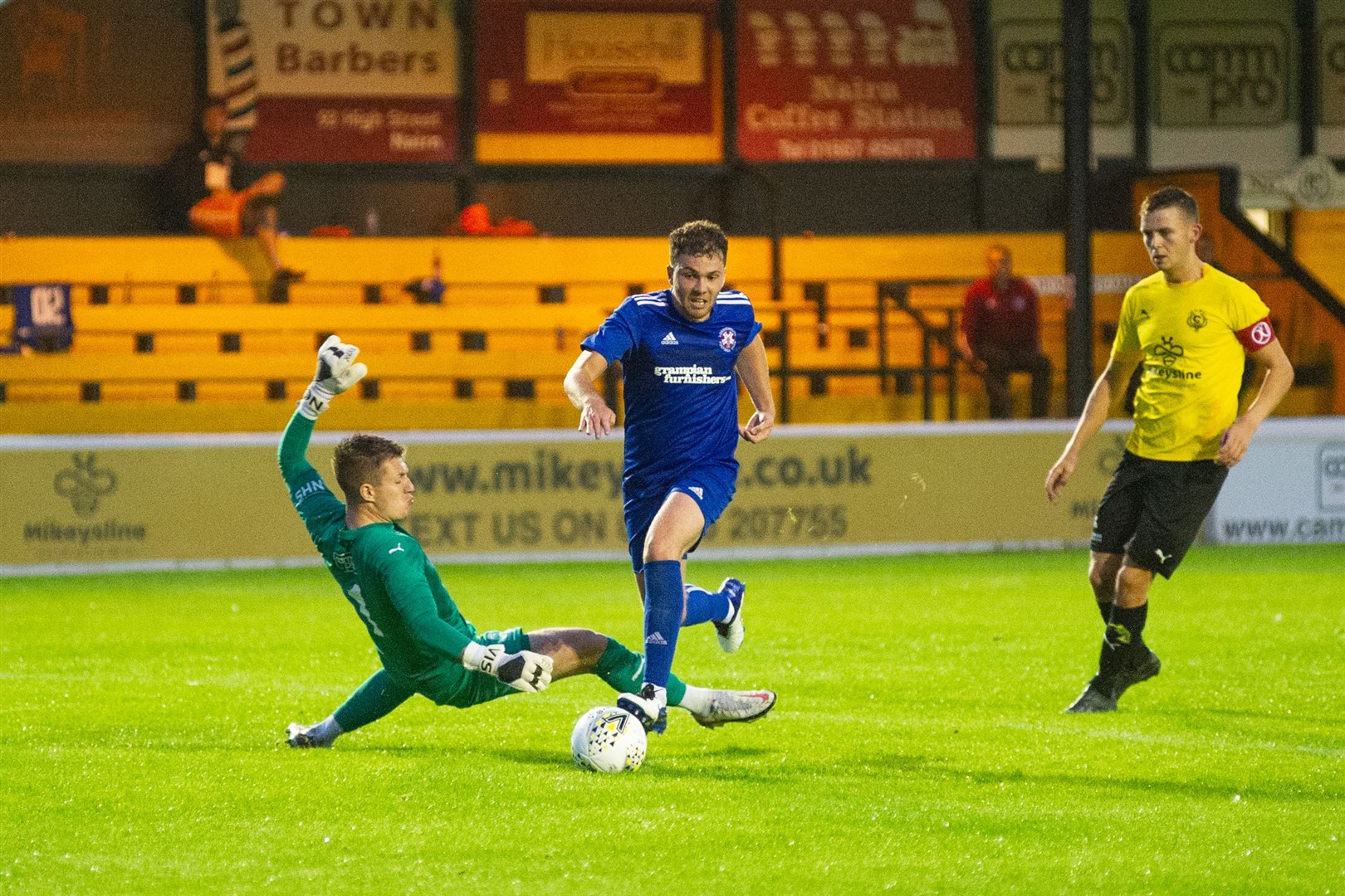 Lossie's Ryan Stuart rounds Nairn goalkeeper Will Counsell to score his hat-trick. Picture: Daniel Forsyth