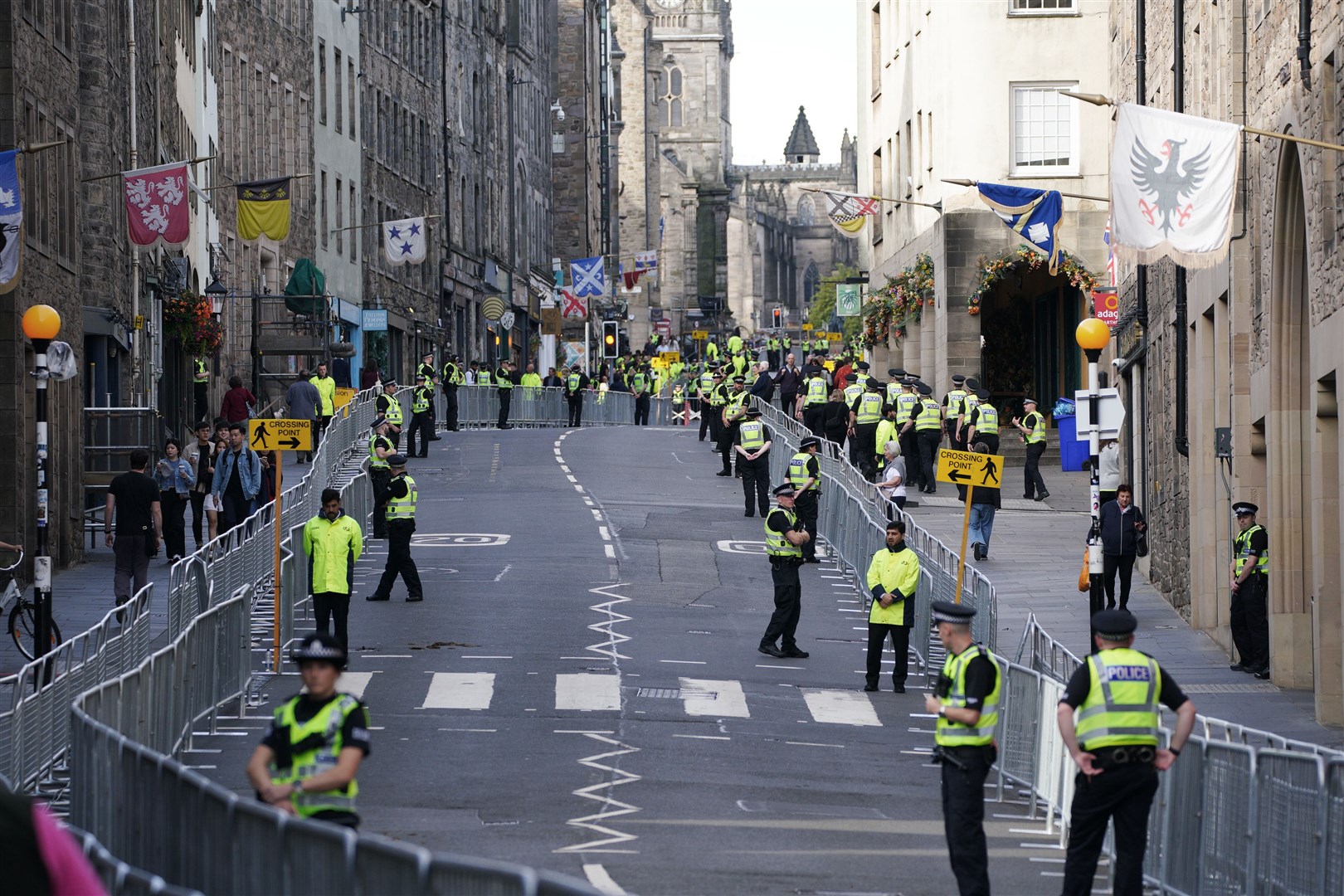Police officers on the Royal Mile in Edinburgh prepare for the cortege (Peter Byrne/PA)
