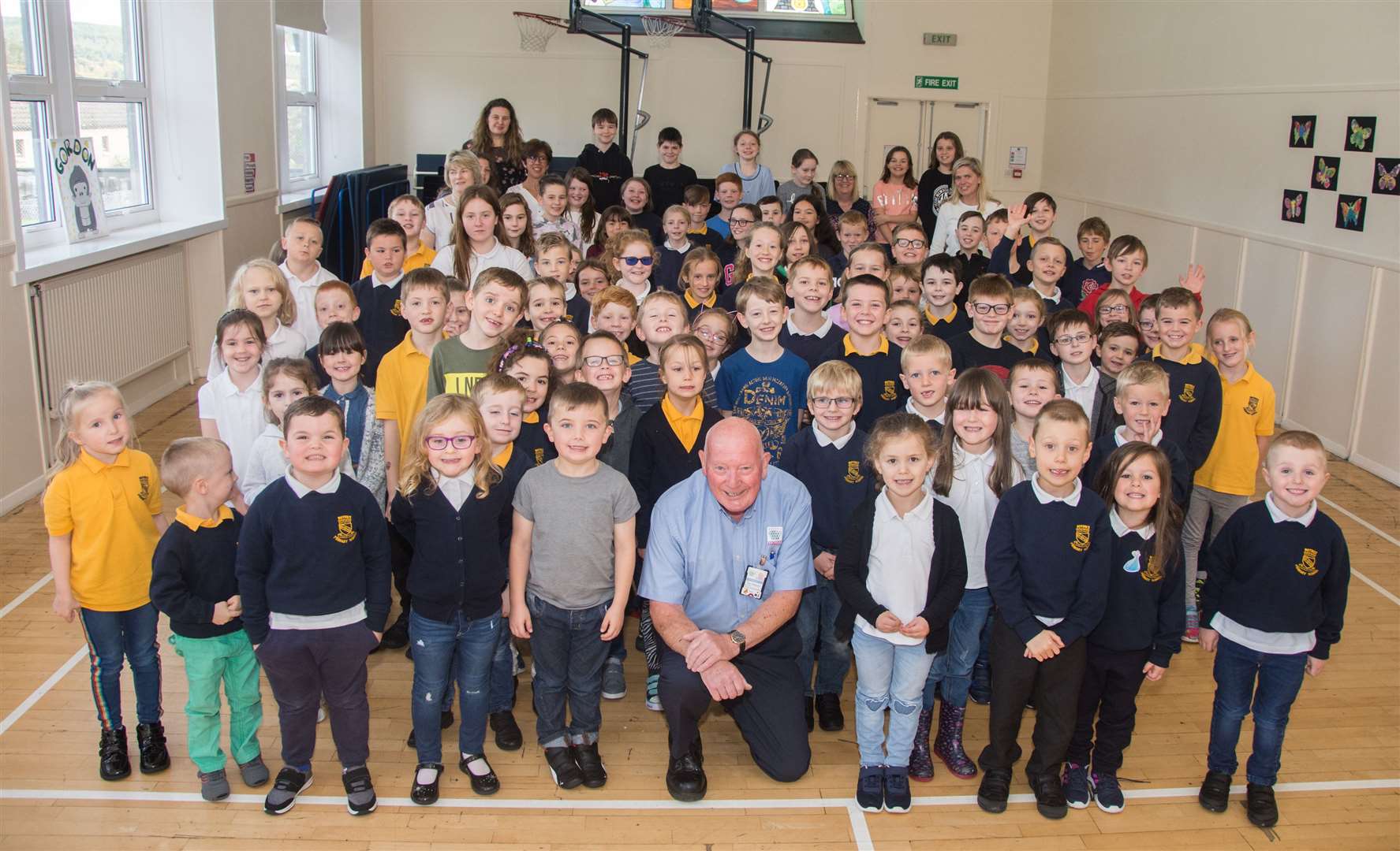 Janitor Eoin McKenzie who is retiring today. He's pictured with youngsters from Rothes Primary who were having a Jeans for Genes day. Picture: Becky Saunderson.