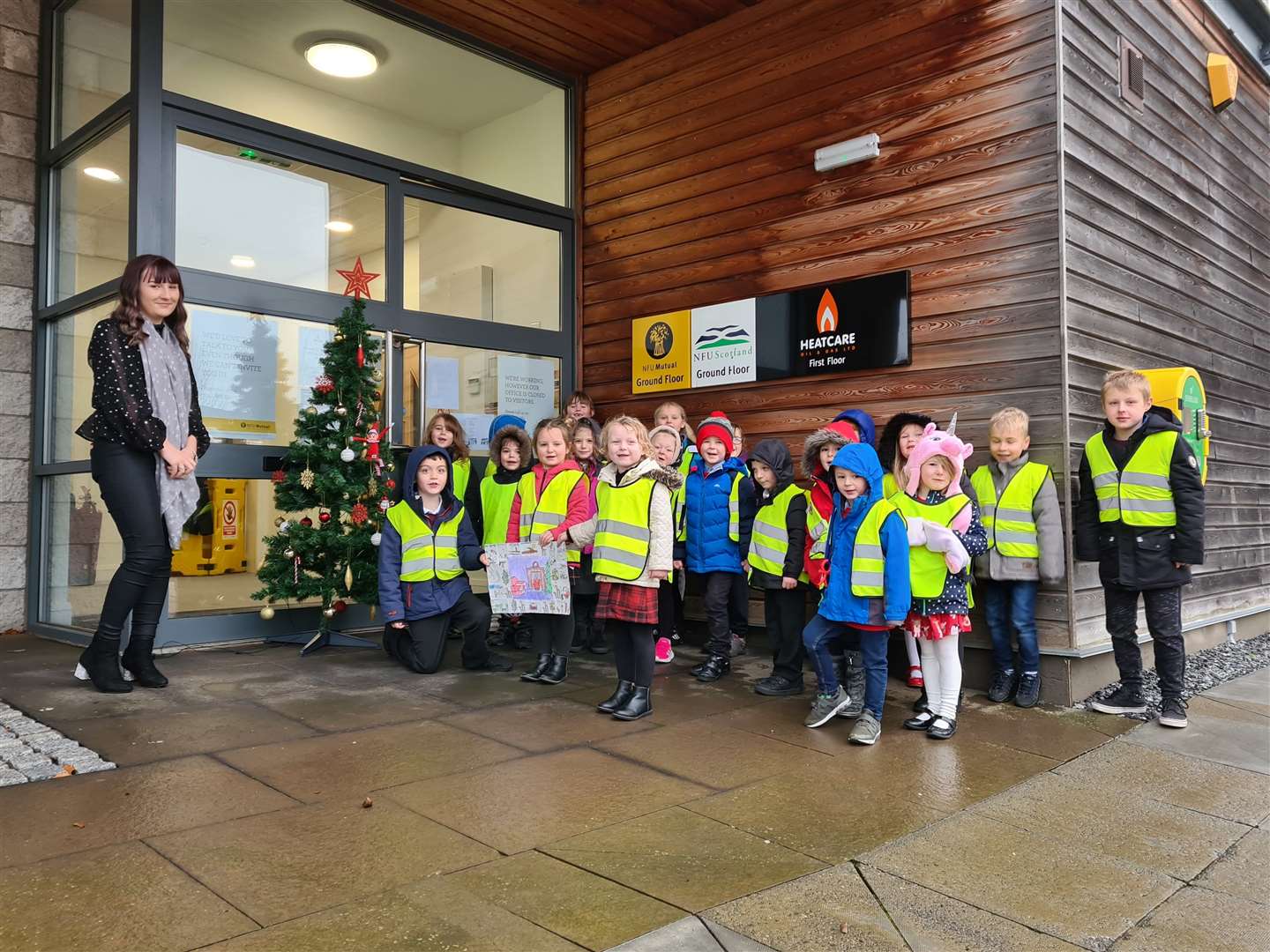 Pupils from St Thomas R C Primary School in Keith pictured handing over their picture to NFU Mutual customer service advisor Alana Smith.