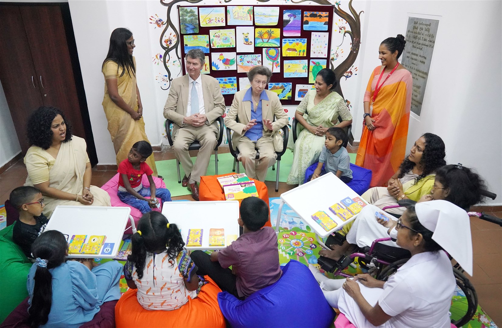 The Princess Royal and Vice Admiral Sir Timothy Laurence engage with a group of children and staff using a social-emotional learning toolkit for children during a visit to the Lady Ridgeway Hospital for Children in Colombo (Jonathan Brady/PA)