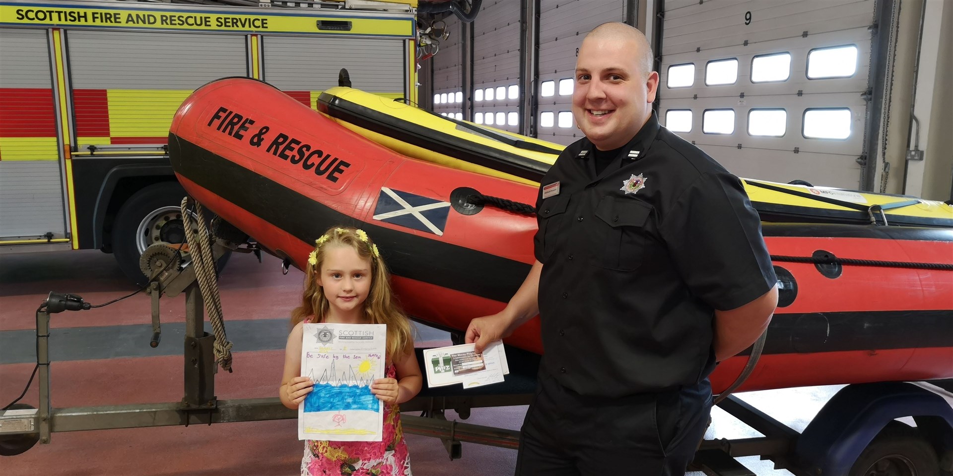 Burghead's Summer Allum (8) meets crew manager Douglas McAulay after winning a poster competition designed to highlight the dangers of open water.