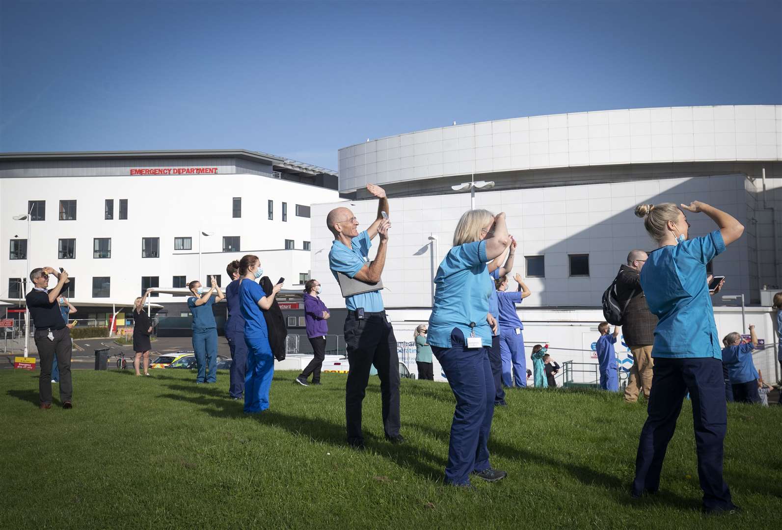 Staff at the Royal Infirmary of Edinburgh watch as the Spitfire passes overhead (Jane Barlow/PA)