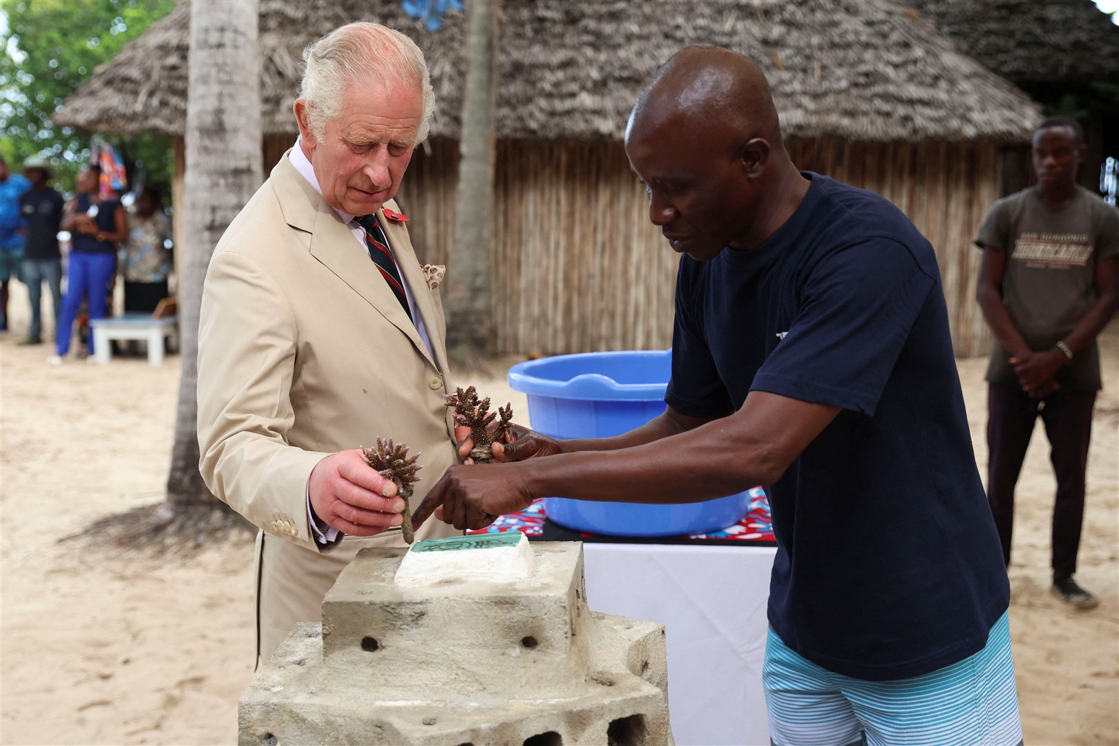The King works to construct part of an artificial reef which was placed off the coast of Mombasa (Phil Noble/PA)