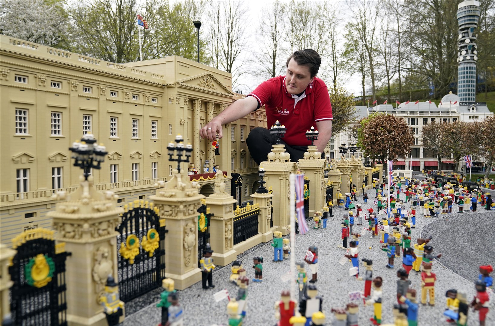 Daniel Anderson from the Legoland Windsor Resort places a Lego model of Charles on the balcony of the miniature Buckingham Palace (Andrew Matthews/PA)