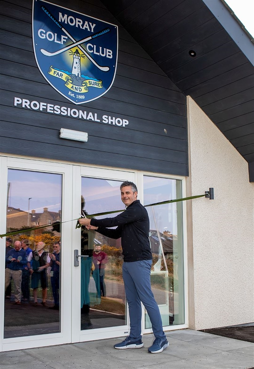 John Murray cuts the ribbon to officially open the new shop. Picture: John MacGregor