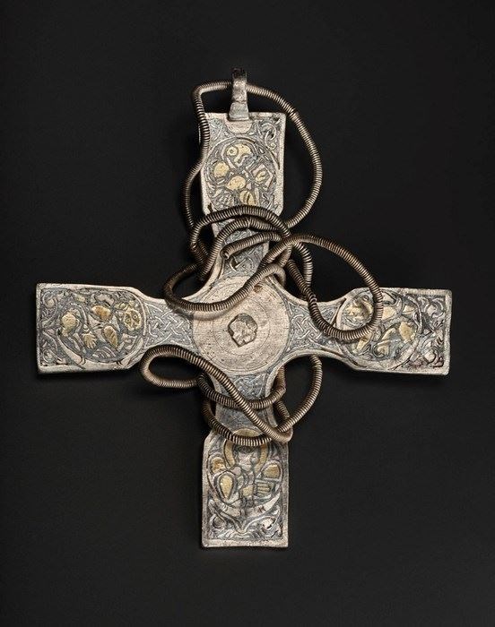 This silver pectoral cross, which may have come from Dublin, is engraved with unusual decorations that could represent each of the four Gospels.