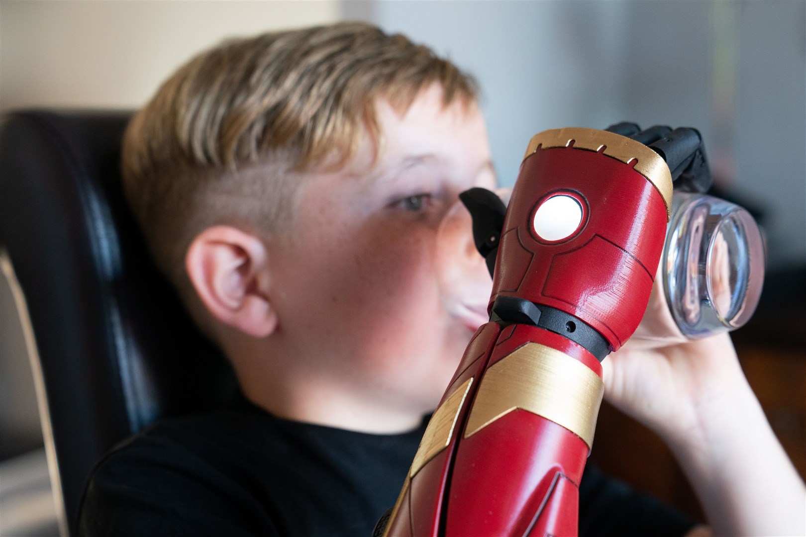 Louie demonstrates his new prosthetic arm called a Hero Arm (Joe Giddens/PA)