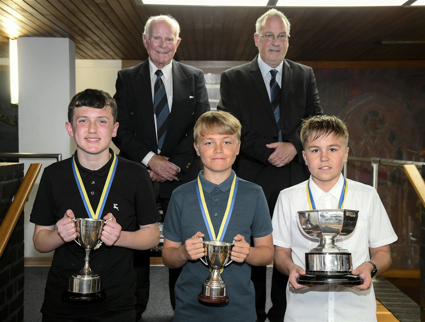 Mike Christie (Honorary President) and Neil Fotheringham (Secretary) along with the Intermediate winners: St Giles, Royal and Corinthians at an Elgin Boys Club Presentation at Elgin Town Hall.