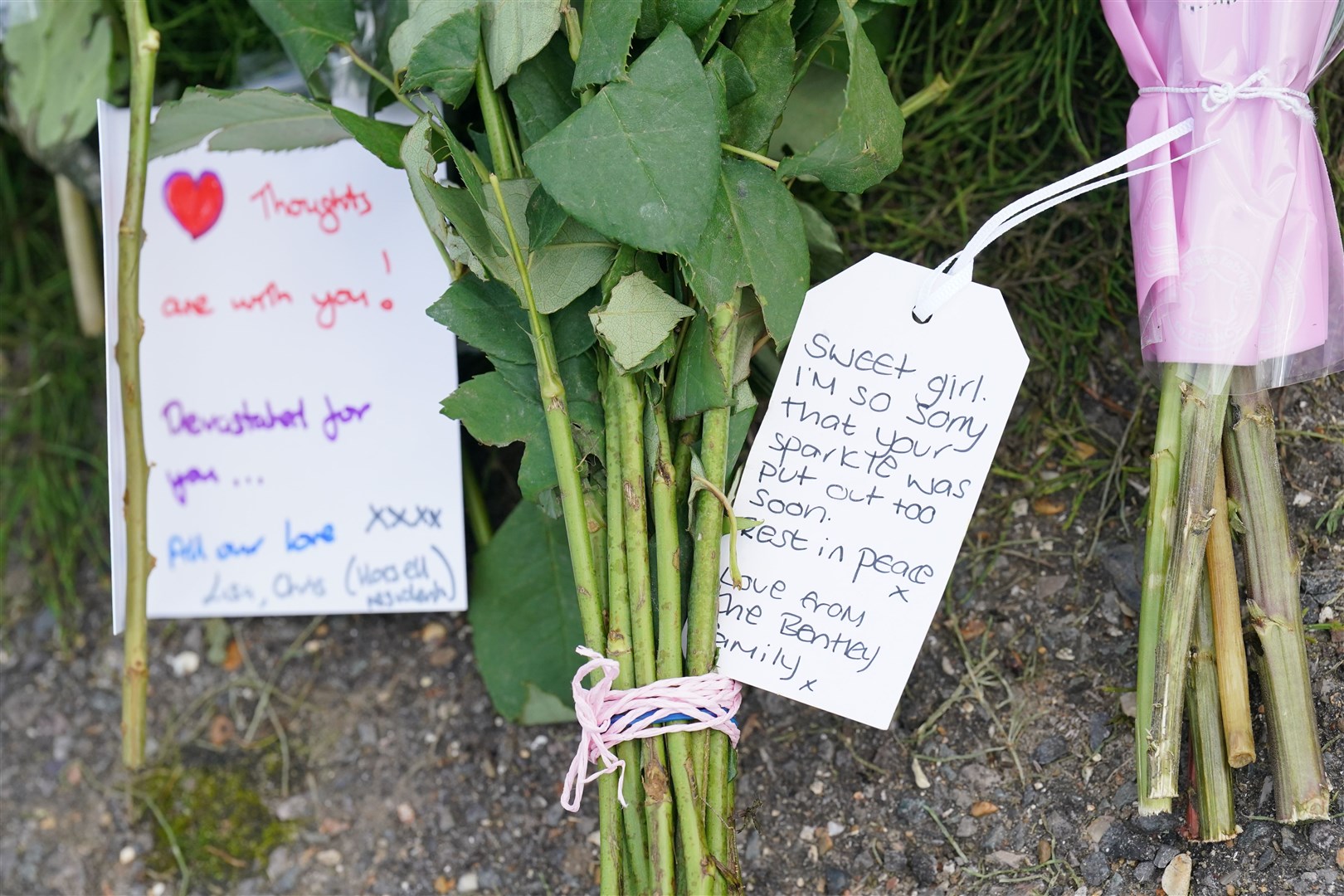 A note left on flowers outside a property on Hammond Road in Woking, Surrey (Jonathan Brady/PA)