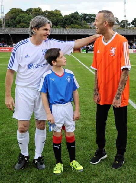 Fernando Ricksen is greeted by former Celtic star Joe Miller during the Dutchman's benefit match at Borough Briggs on Sunday. Photo by Eric Cormack.