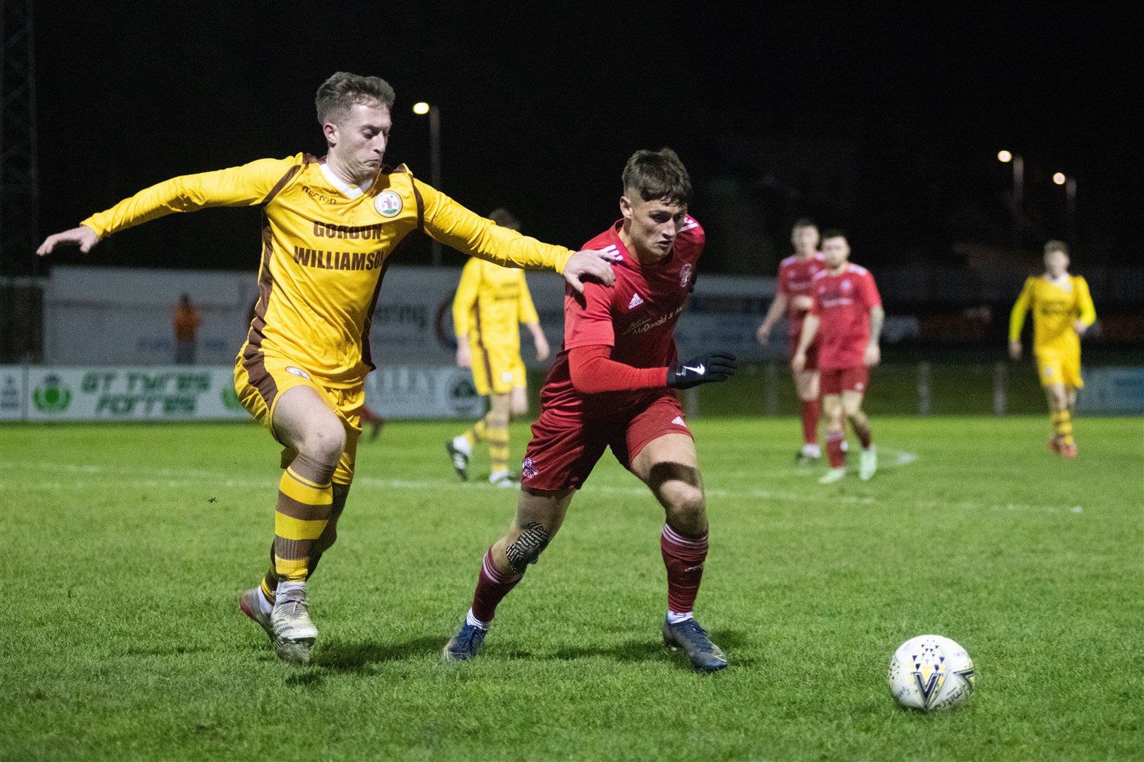Forres' Dale Wood tries to get a hand on Lossie winger Ross Elliott...Forres Mechanics FC (1) vs Lossiemouth FC (0) - Highland Fotball League 22/23 - Mosset Park, Forres 23/12/22...Picture: Daniel Forsyth..