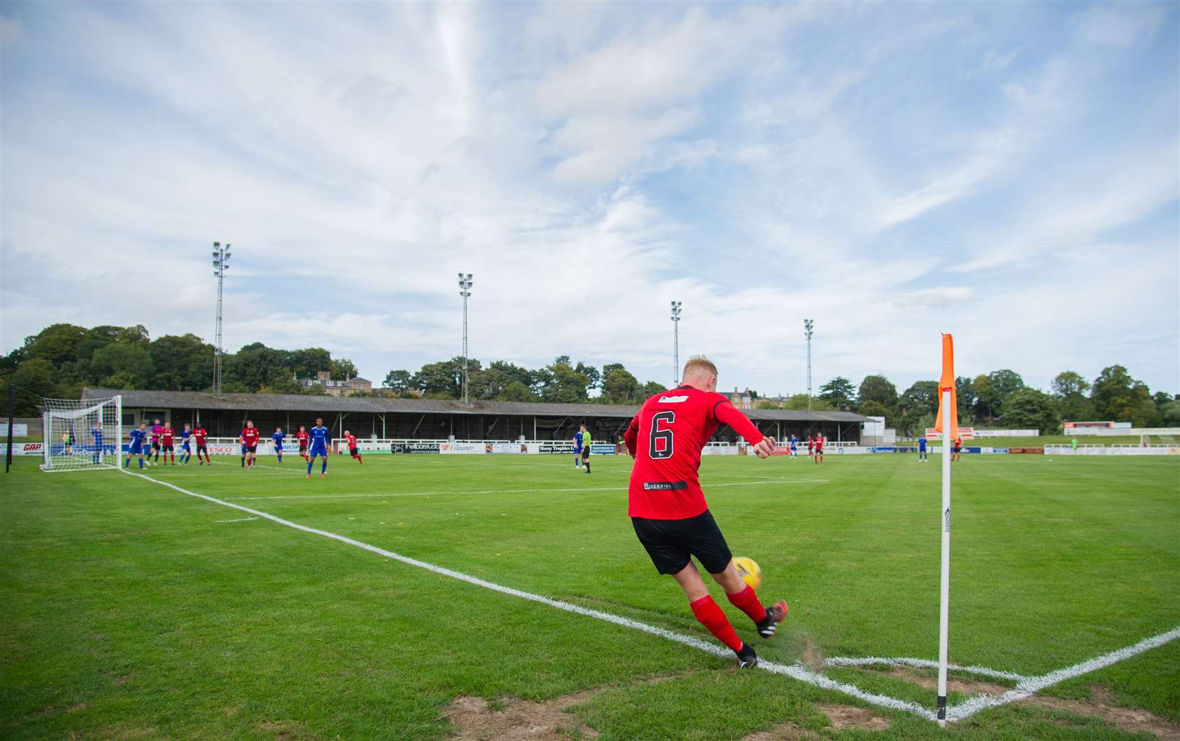 Empty terraces as Russell Dingwall takes a corner for Elgin. Picture: Daniel Forsyth..