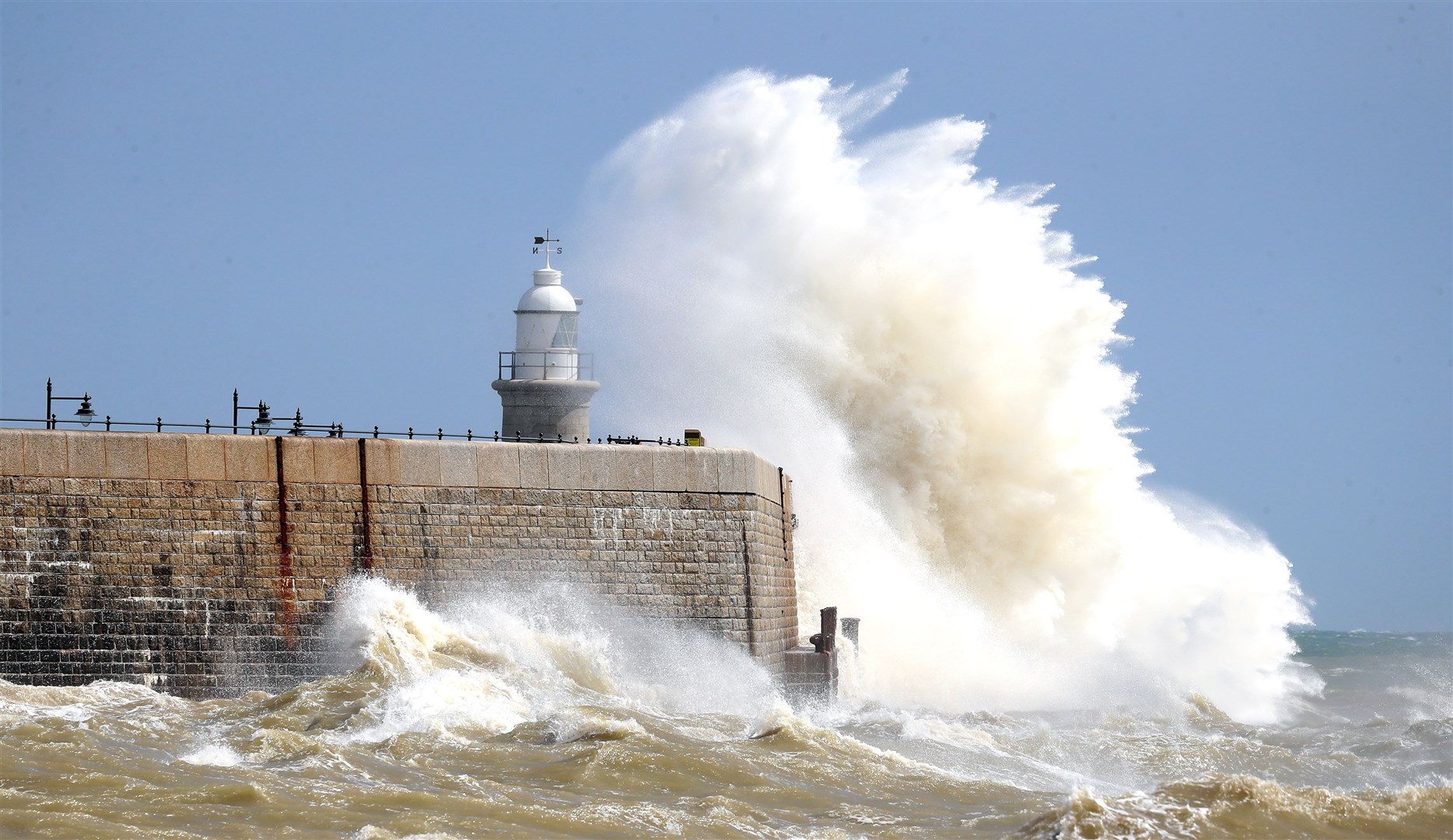 Waves crash over the harbour wall in Folkestone, Kent, on August 21 (Gareth Fuller/PA)