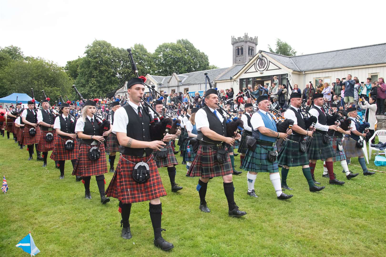 The Massed Pipe Band make their way around the games arena...77th Aberlour Strathspey Highland Games held on Saturday 6th August 2022...Picture: Daniel Forsyth..