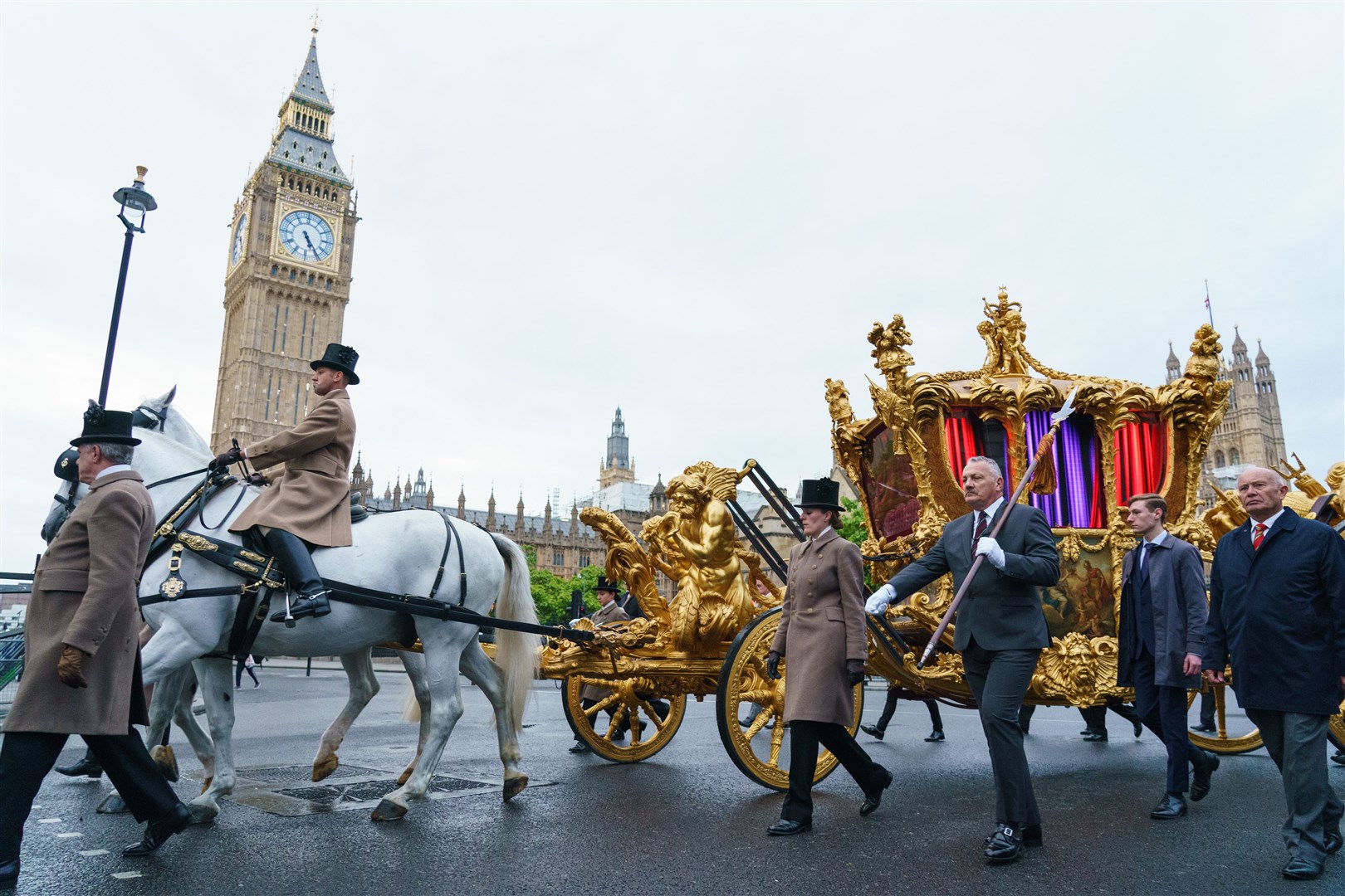 The gold state coach passes the Houses of Parliament during an early morning rehearsal (Dominic Lipinski/PA)