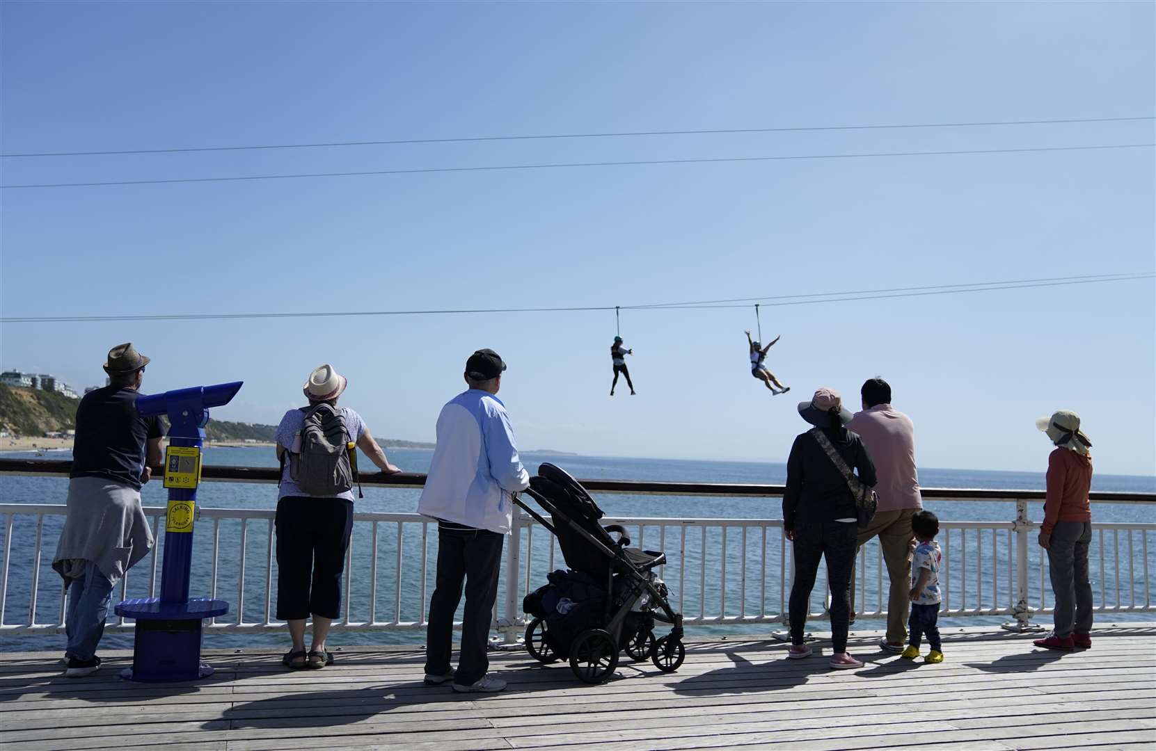 People watch on as some dare to try the zip wire from Bournemouth pier to the beach (Andrew Matthews/PA)