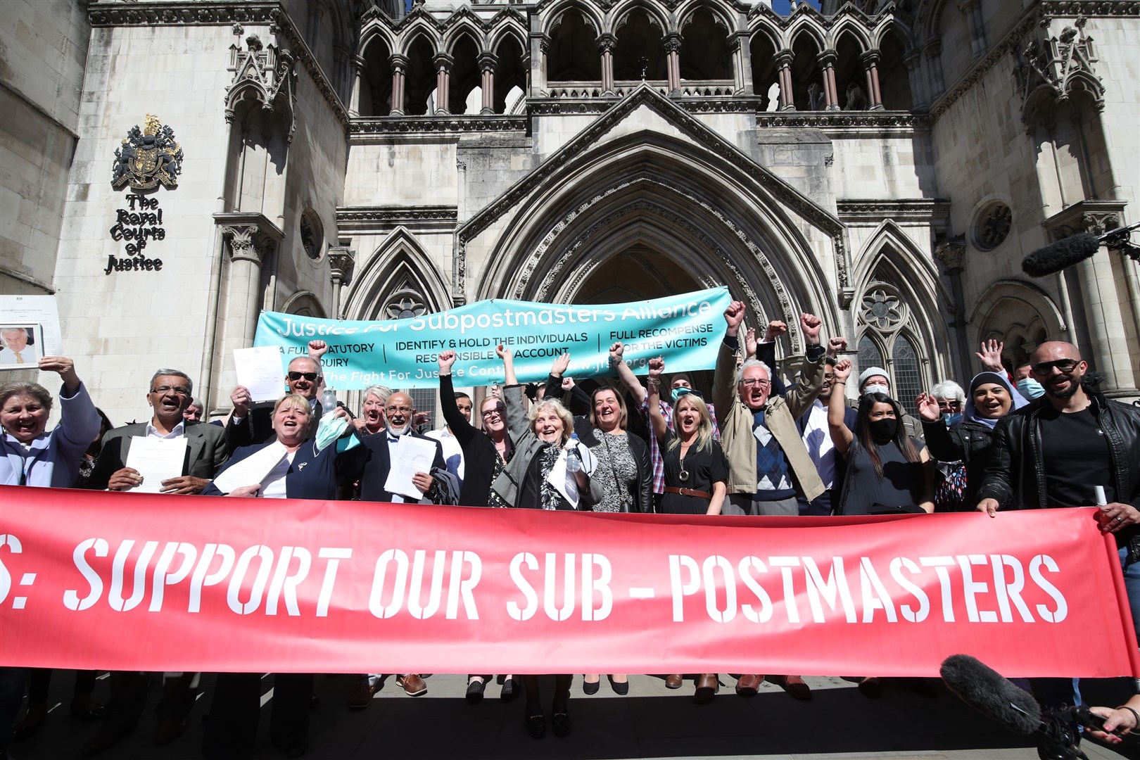 Former post office workers celebrate outside the Royal Courts of Justice, London, after having their convictions overturned by the Court of Appeal (Yui Mok/PA)