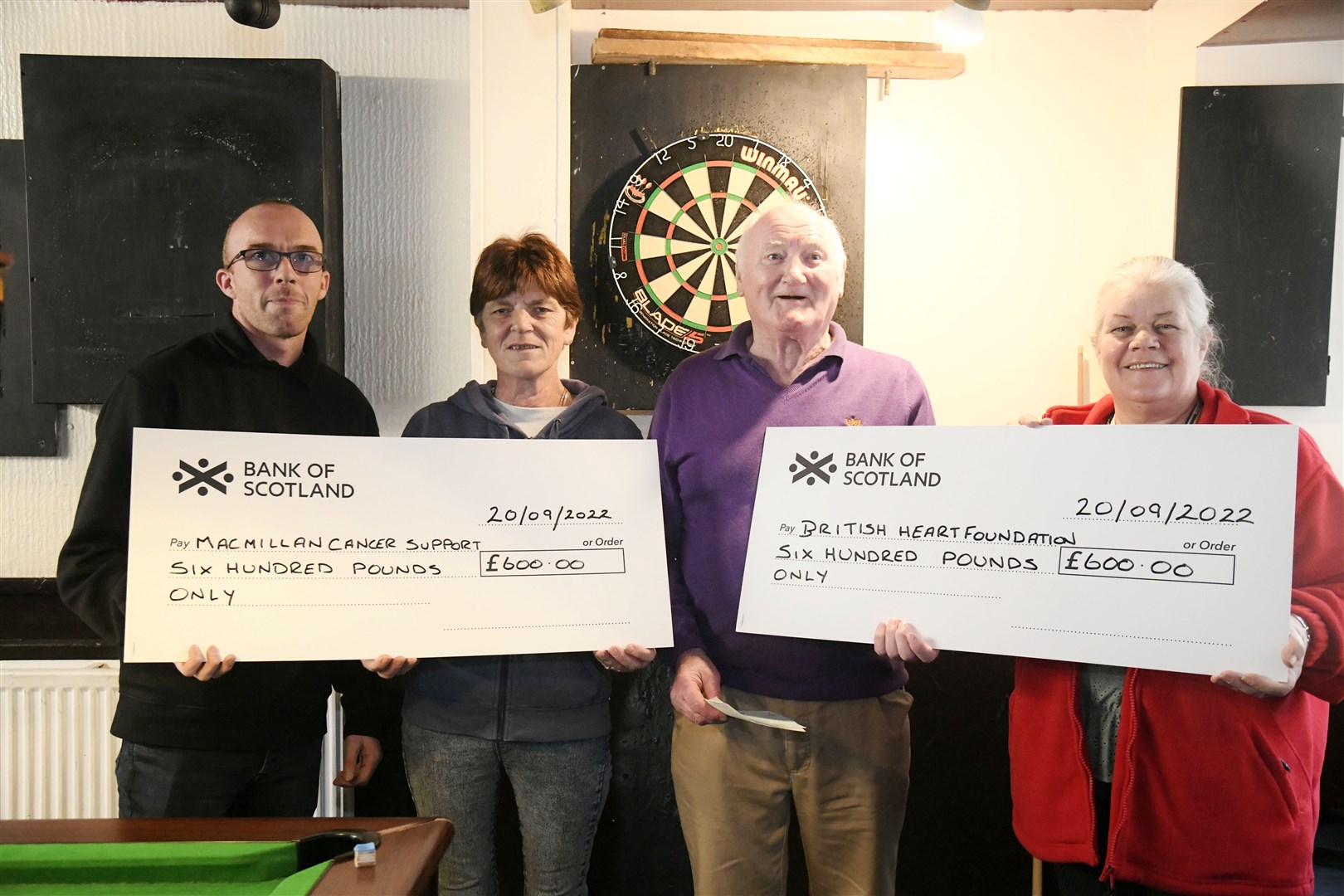From left: John Milne (C&R Taxi's), Patricia Ross, Bill Ross and Joanne Hewitt (British Heart Foundation - Store Manager) both receiving Jean Ross Memorial Shield cheques. ..Picture: Beth Taylor.