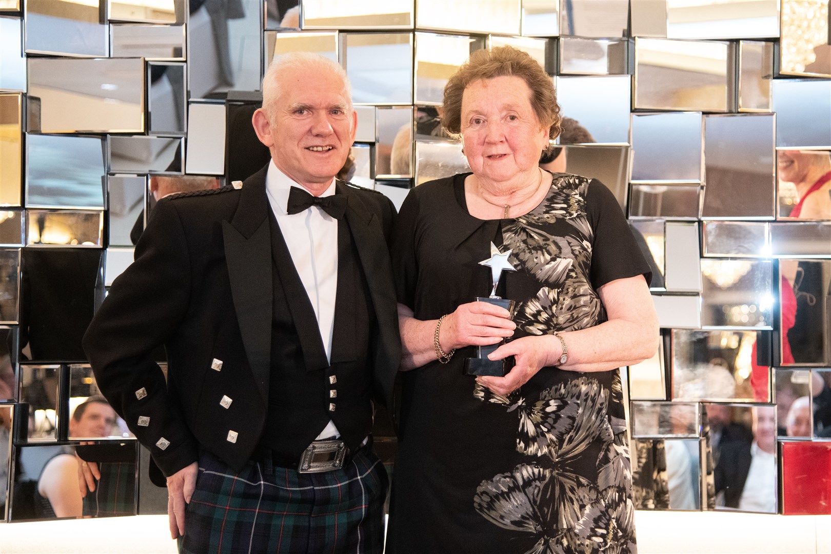 Volunteer of the year Carol Robertson accepts her award from Frank Reid of Robertson Group. Picture: Daniel Forsyth
