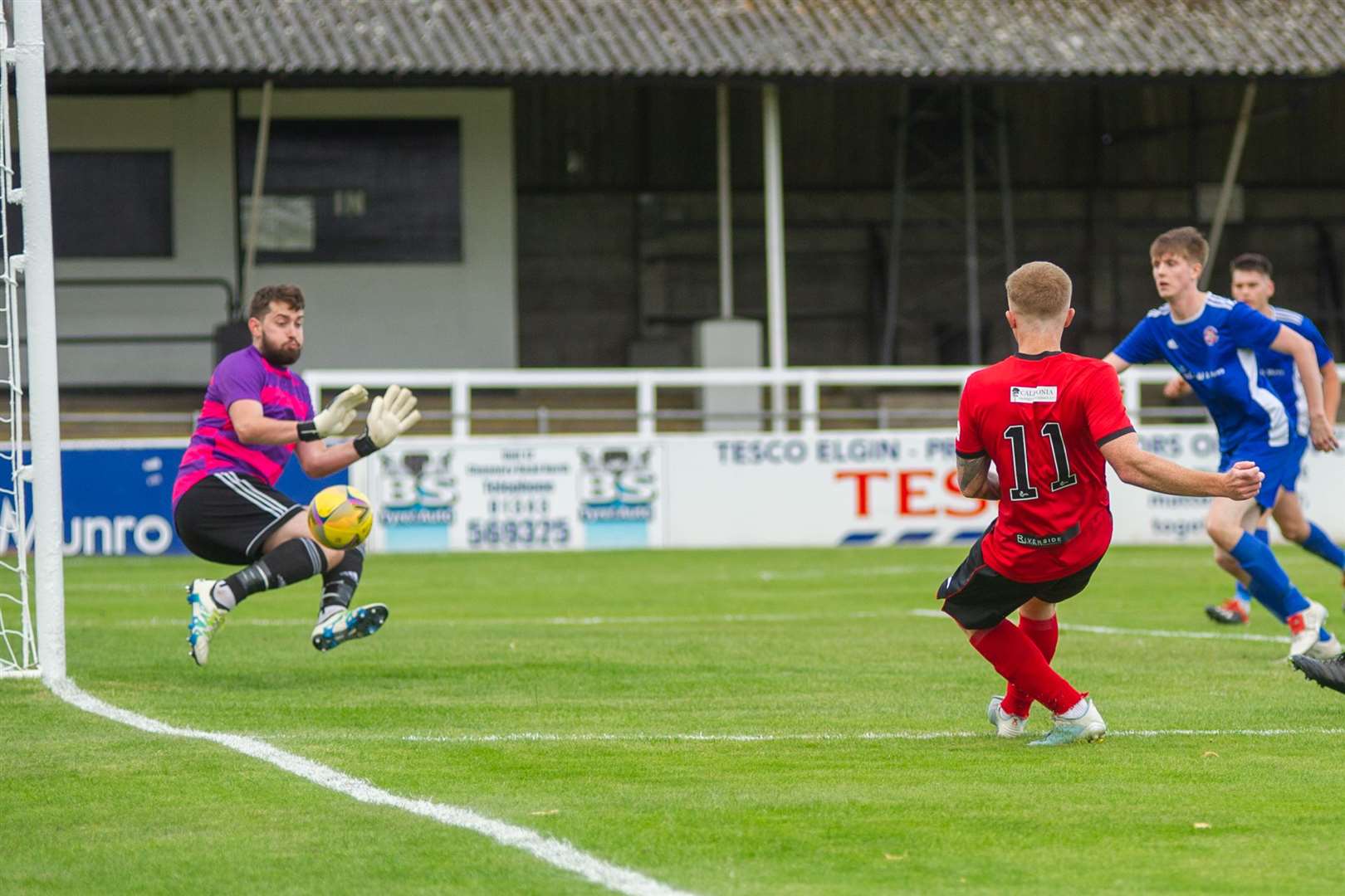 Lossiemouth goalkeeper Stewart Black pulls of a save from Conor O'Keefe. Picture: Daniel Forsyth..