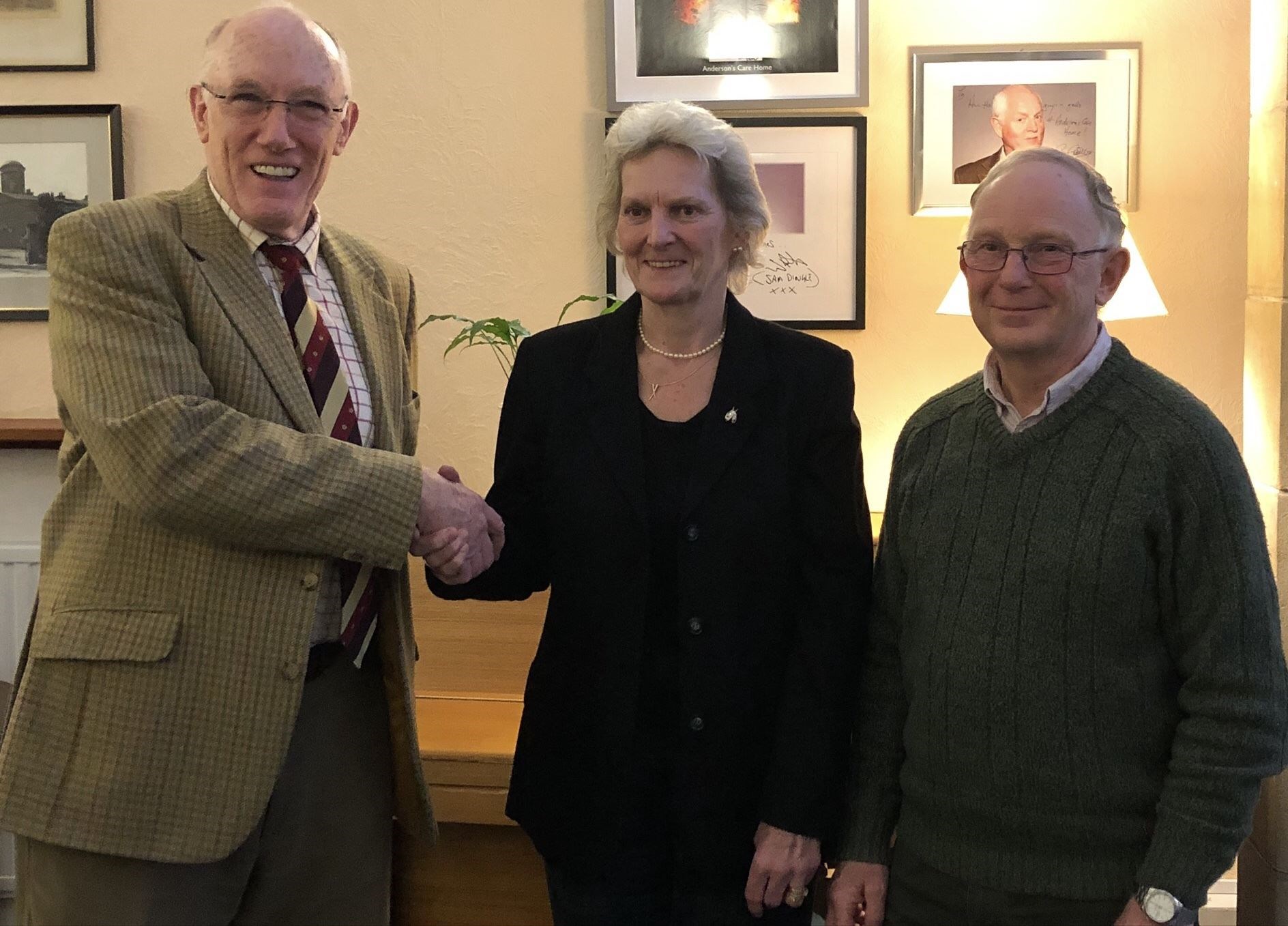 Outgoing chairman of Anderson's Care Home David Evans (left) hands over the post to Issie Graham, with Iain Jamieson as vice-chairman.