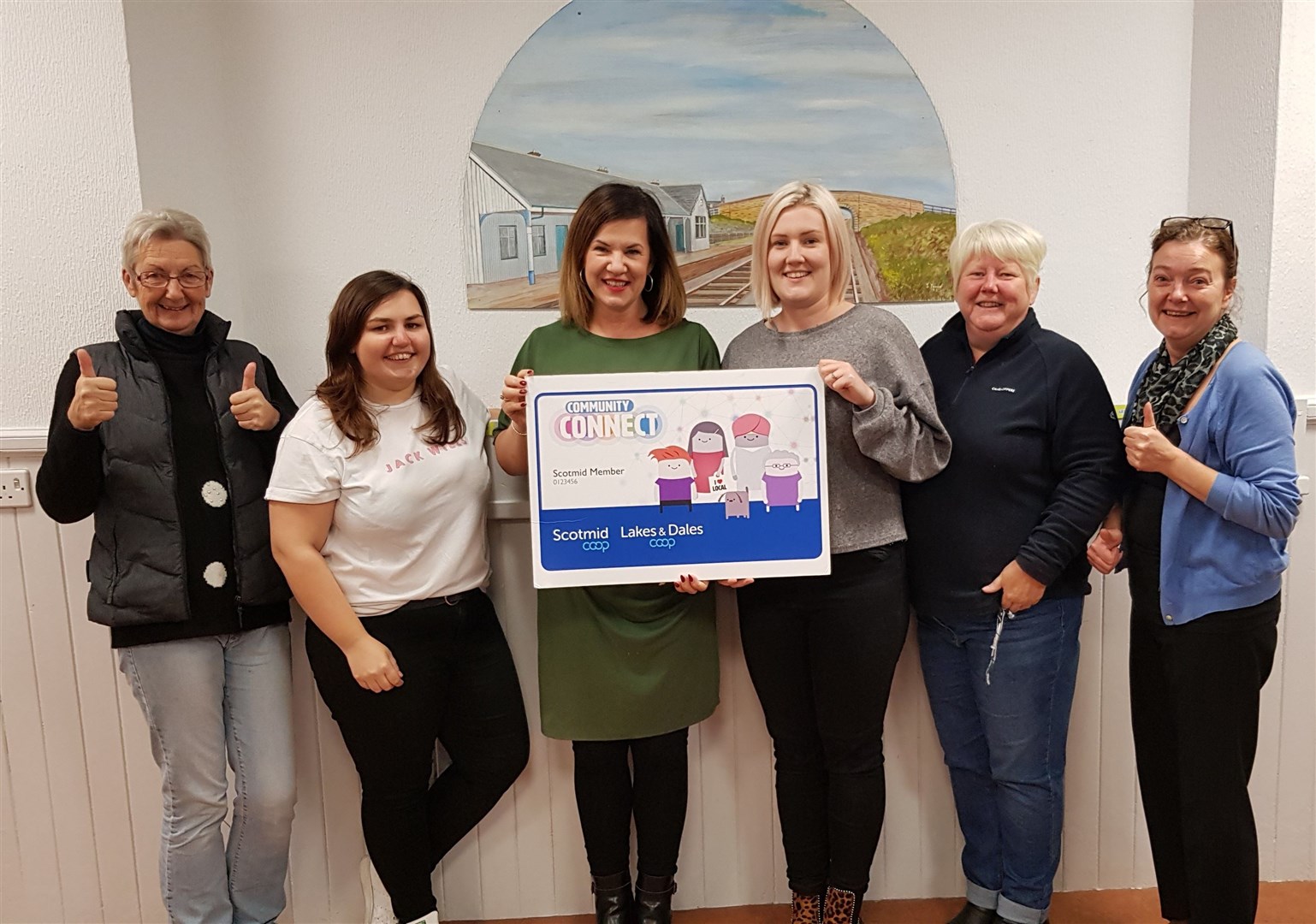 Prior to social distancing restrictions, members of the Burghead Community Hall committee celebrate making the shortlist for Scotmid Co-operative’s Community Connect award scheme.