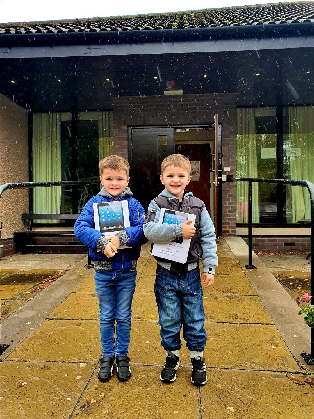 From left, local youngsters Harvey and Archie Spark drop off iPads to Speyside Care Home, in Aberlour.
