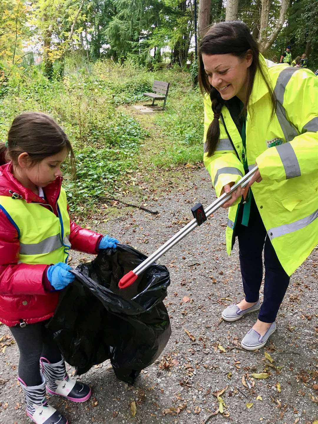 Milne's Primary headteacher Kim Karam and pupil Nicola deal with some litter. Picture: Milne's Primary