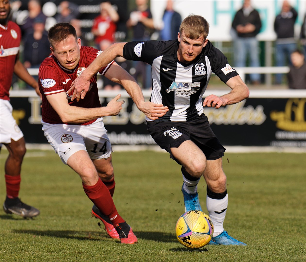 Aiden Sopel of Elgin City gets pulled by Ross Philp. Photo: Bob Crombie
