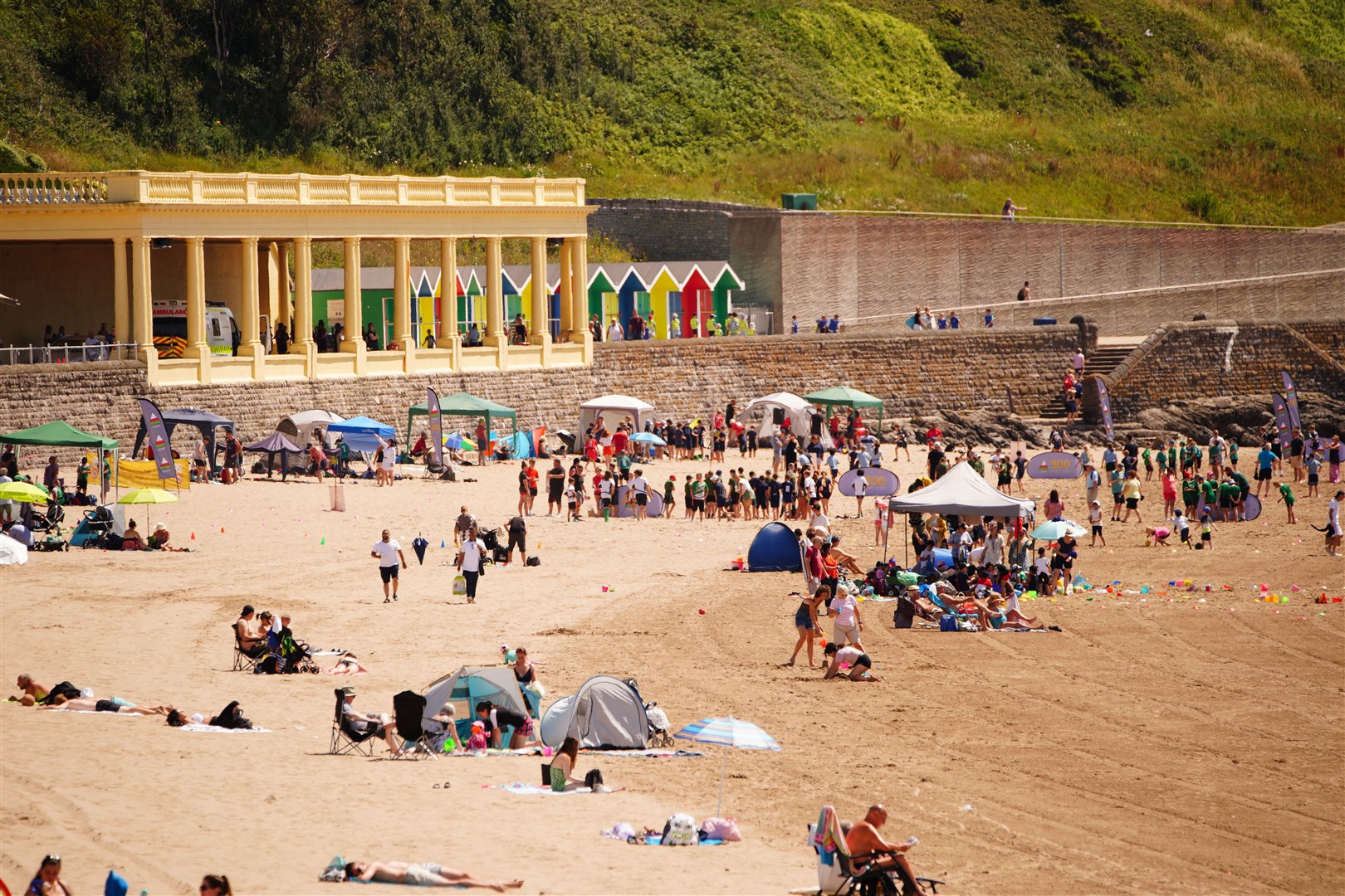People on the beach at Barry Island enjoying the hot weather (Ben Birchall/PA)