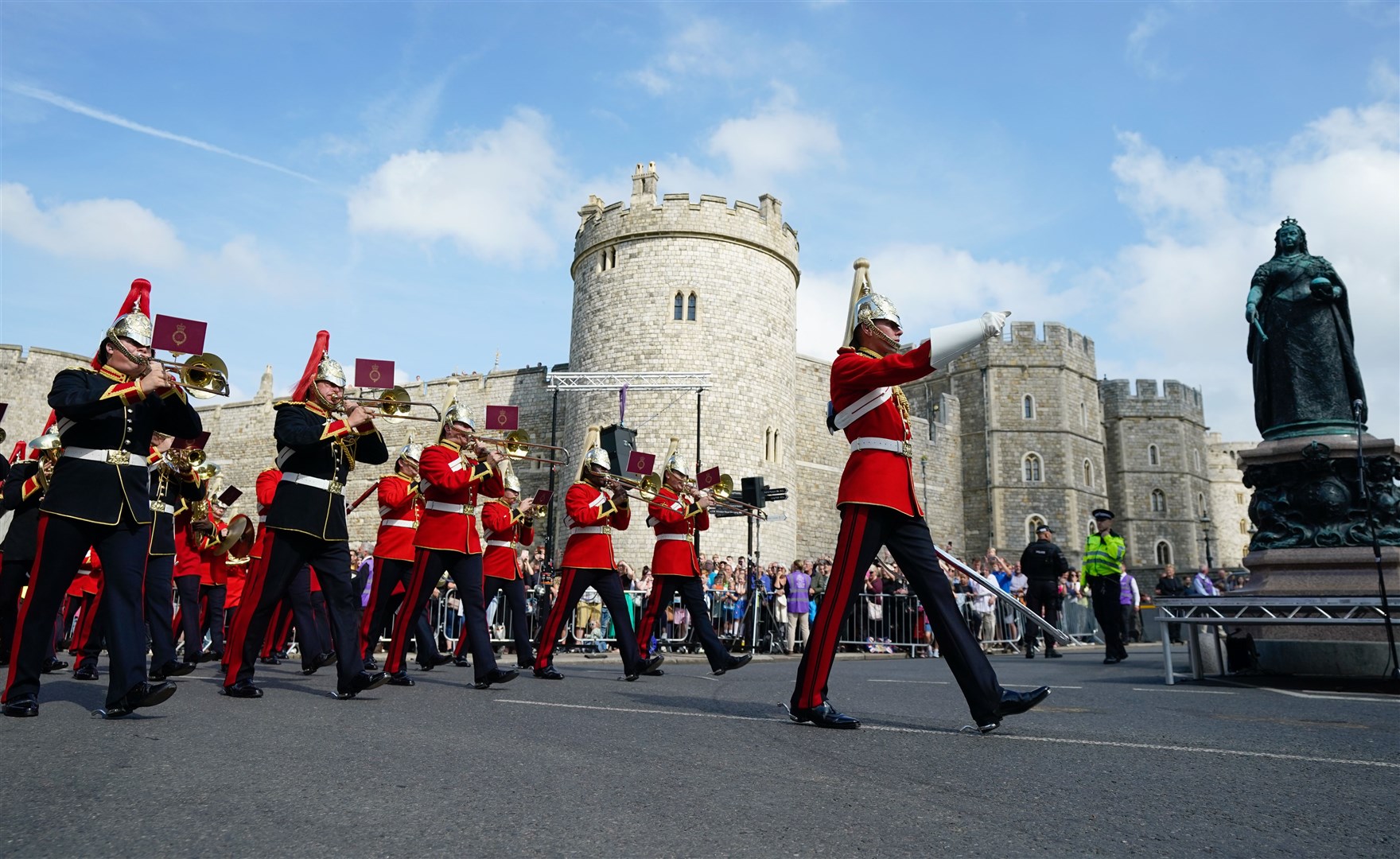 The band of The Household Cavalry march past a statue of Queen Victoria following an accession proclamation ceremony at Windsor Castle (Andrew Matthews/PA)