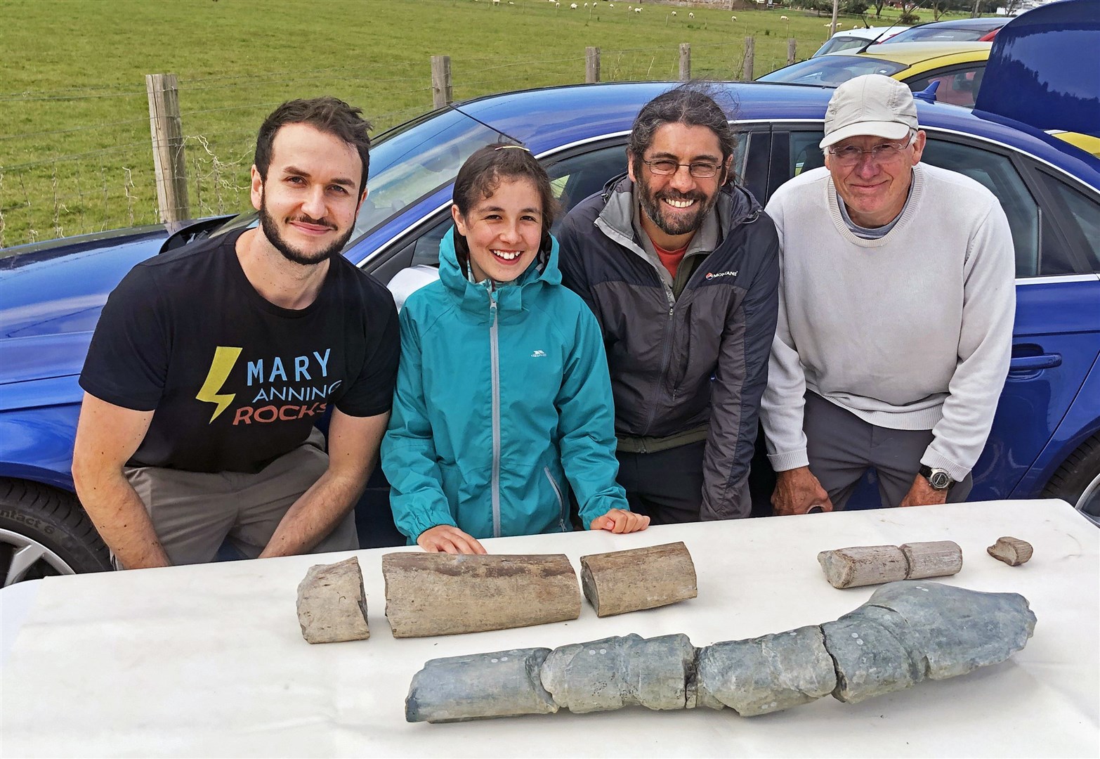 Dr Dean Lomax, Ruby Reynolds, Justin Reynolds and Paul de la Salle look at the fossils (Dr Dean Lomax/PA)
