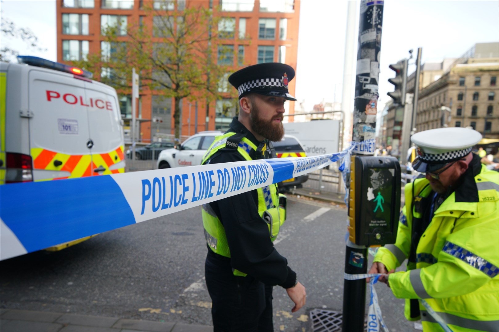 Police officers at the cordon in central Manchester (Peter Byrne/PA)
