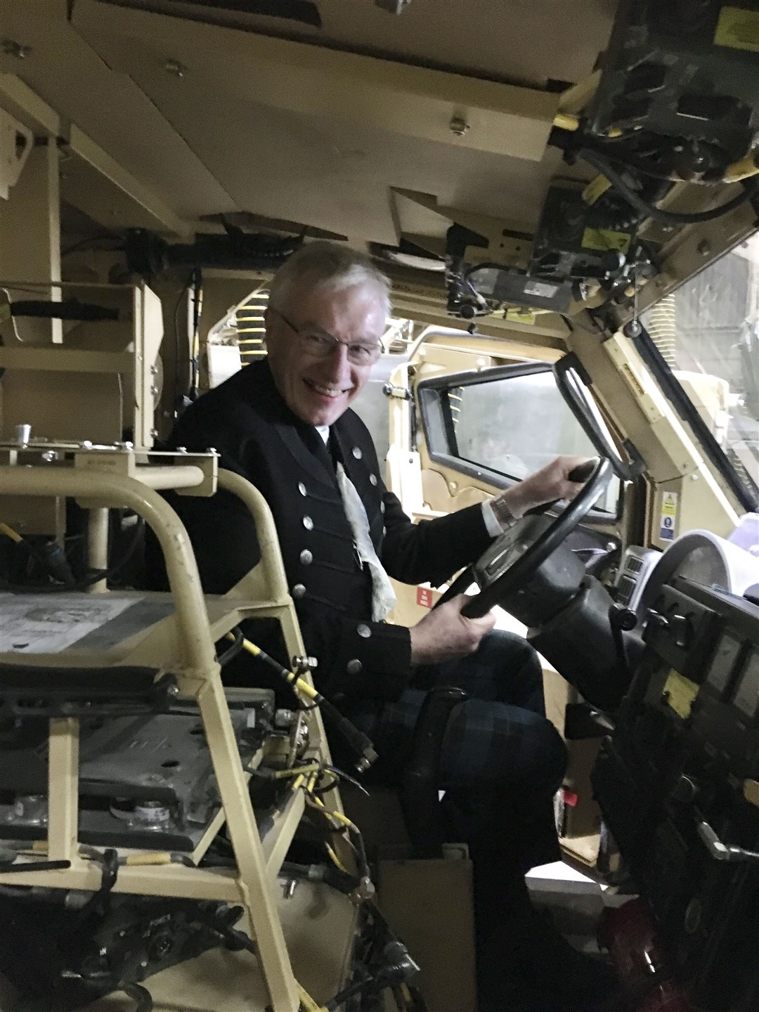 The Rt Rev Colin Sinclair gets behind the wheel of a military vehicle during a visit to Kinloss Barraacks.