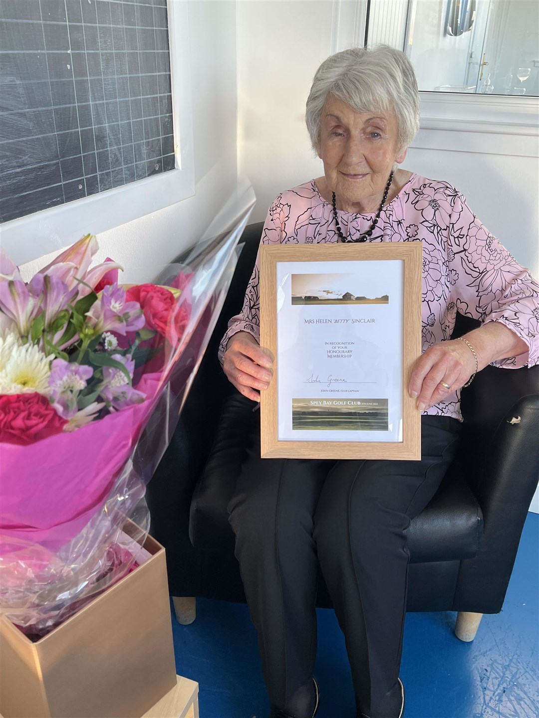 Helen 'Betty' Sinclair proudly shows off her honorary membership to Spey Bay Golf Club. Picture: Spey Bay GC