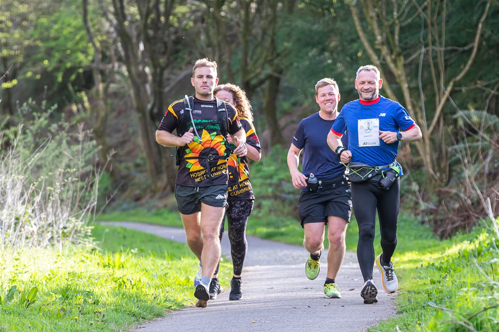 Gary McKee, 53, with supporters, running one of his 365 marathons (Carlos Reina/PA)
