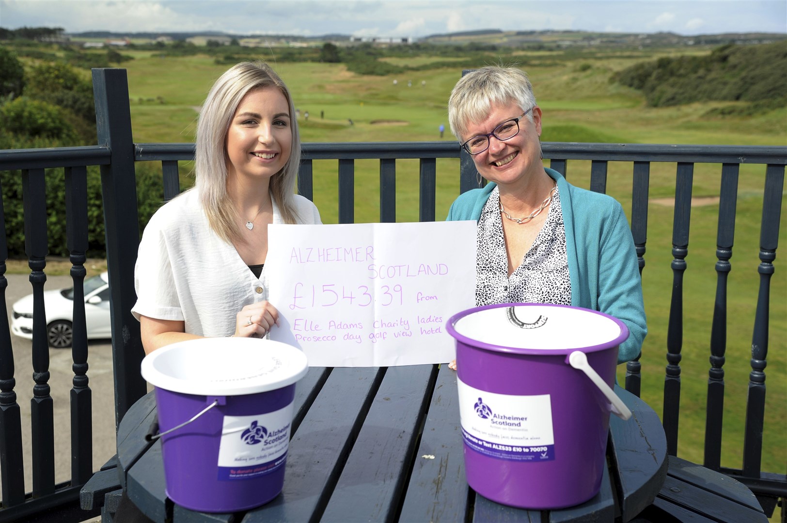 Elle Adams (left) hands over a cheque for £1543 to Alzheimer Scotland Moray advisor Wendy Menzies after a ladies day at the Golf View Hotel in Lossiemouth.