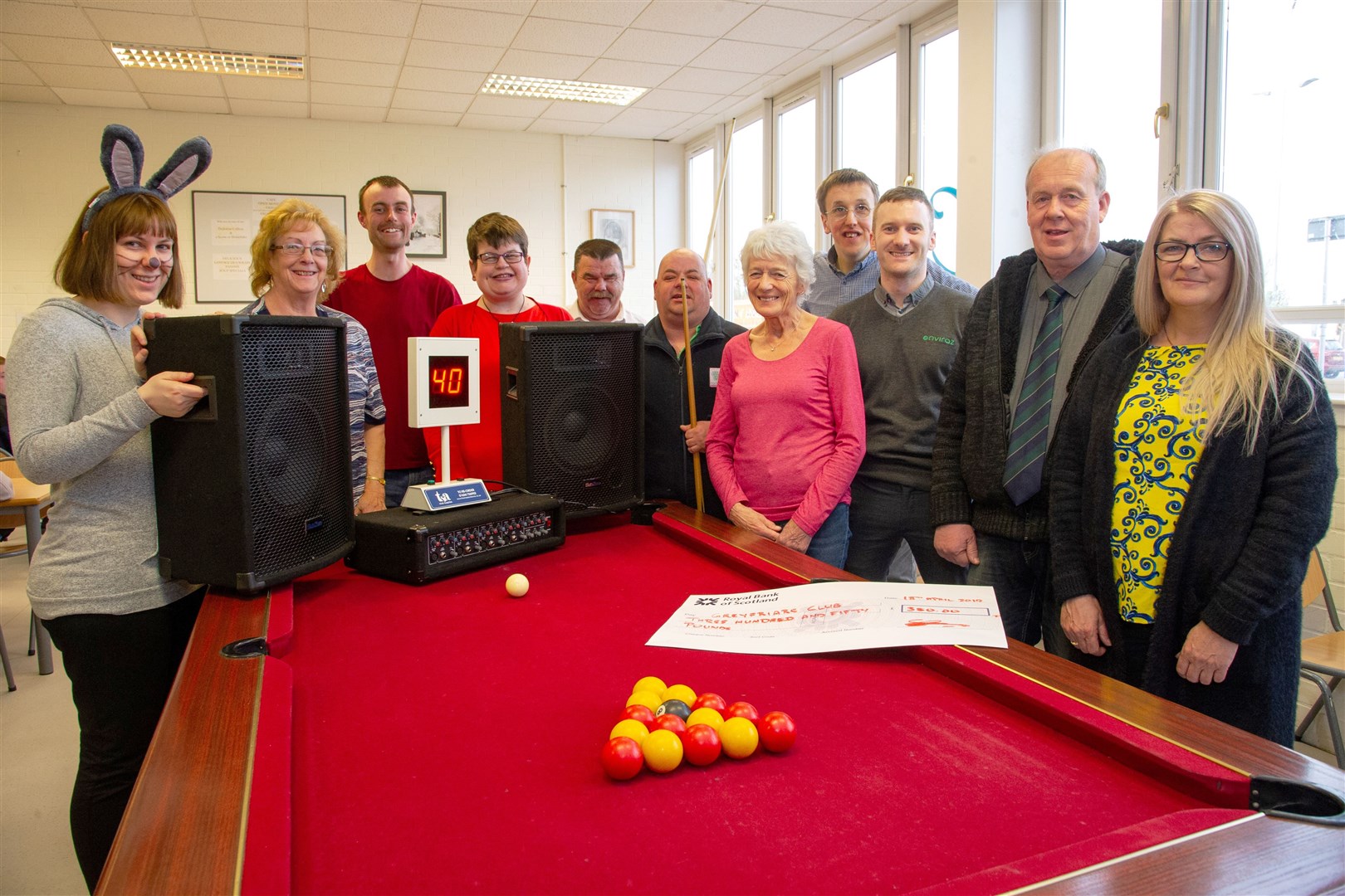 Greyfriars Club members and volunteers with their new pool table, which was donated by (far right) Walter Meldrum and Sandra Ritchie from the Golden Pheasant bar. Thanks to local donations, as well as £350 from Stephen McMullan of Enviraz (third right), the club has enough money to ensure its upkeep and is also enjoying a new bingo machine and music centre. Picture: Daniel Forsyth. Image No.043687.