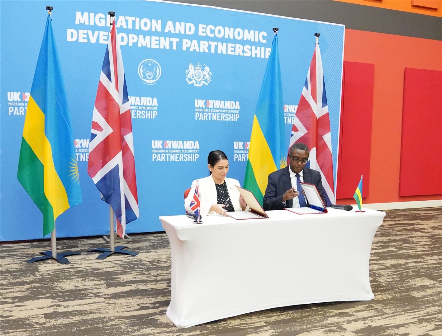 Priti Patel and Rwandan minister for foreign affairs and international co-operation Vincent Biruta, signing the deal (Flora Thompson/PA)