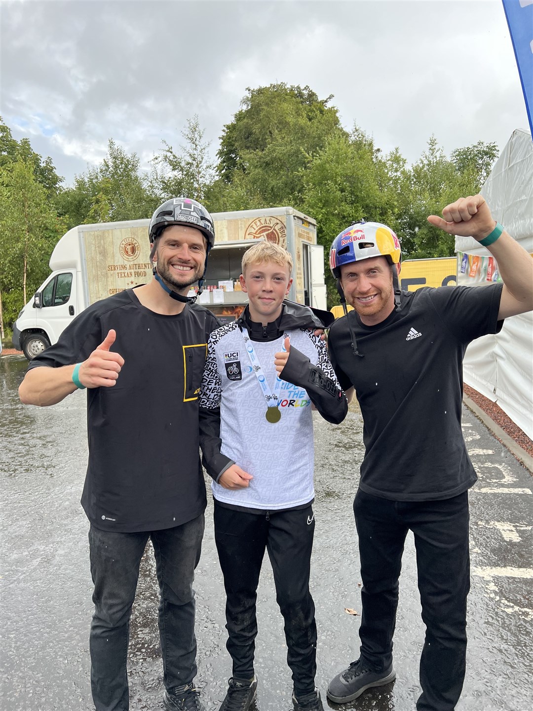 Caleb Rigg celebrates his success with legendary trial biking stars Duncan Shaw (left) and Danny MacAskill.