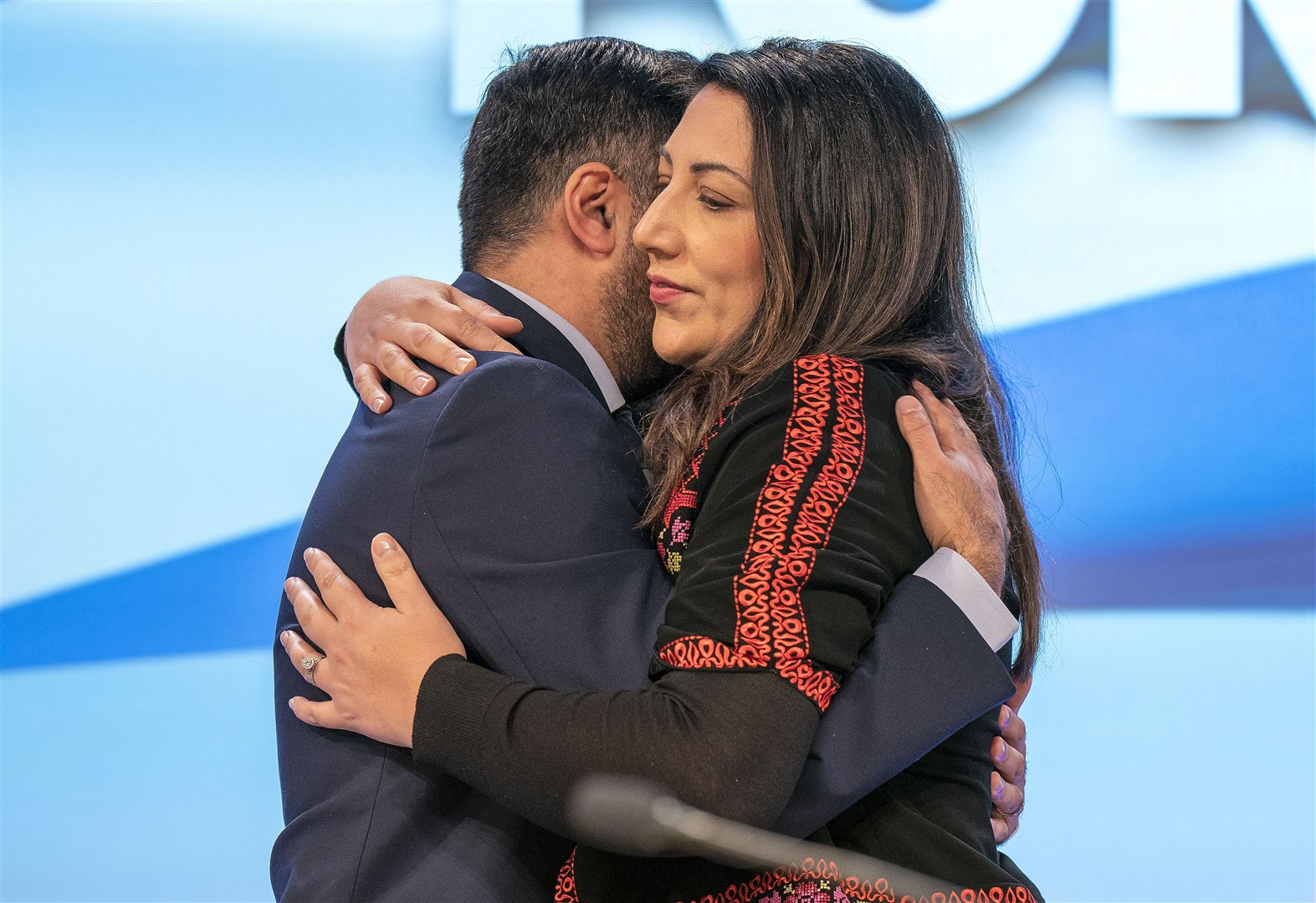 Nadia El-Nakla was embraced by her husband Humza Yousaf on stage a the SNP conference (Jane Barlow/PA)