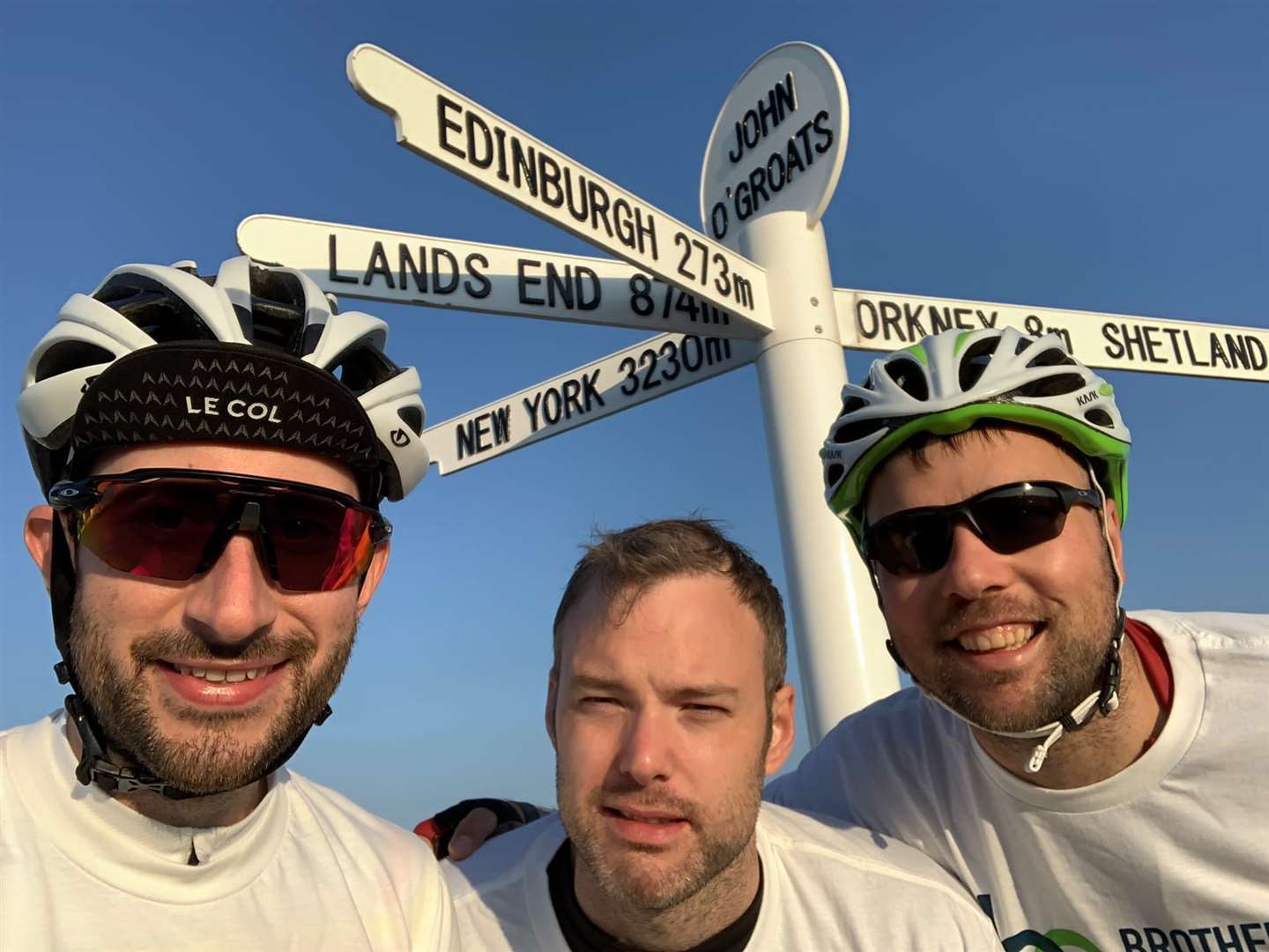 Charity cyclists Ian Johnston and Jamie Ritchie with support driver Callum Ritchie at John o' Groats on Wednesday morning.