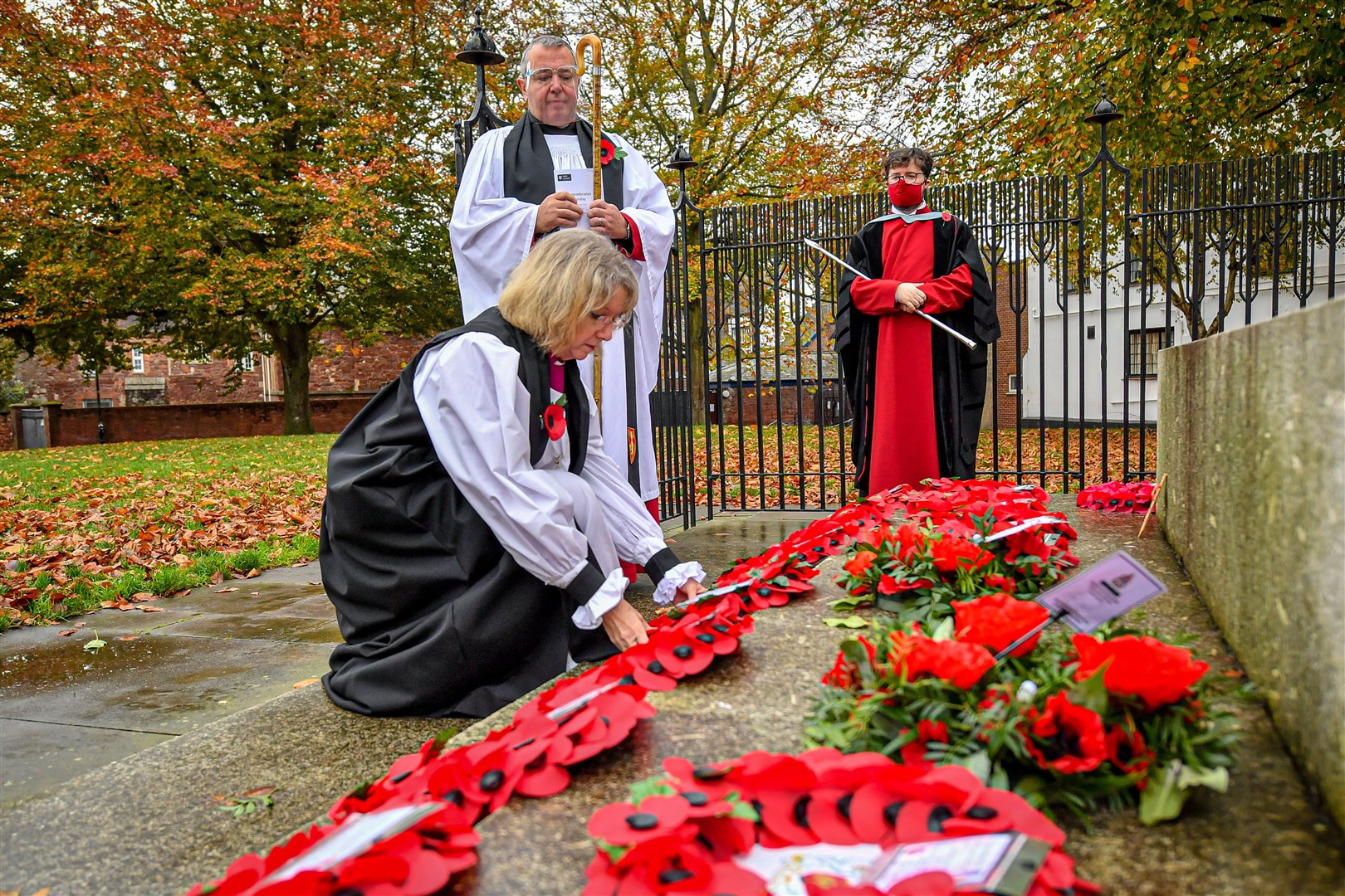 The Right Reverend Jackie Searle Bishop of Crediton lays a wreath at the war memorial after a closed and socially distanced remembrance service at Exeter Cathedral (Ben Birchall/PA)