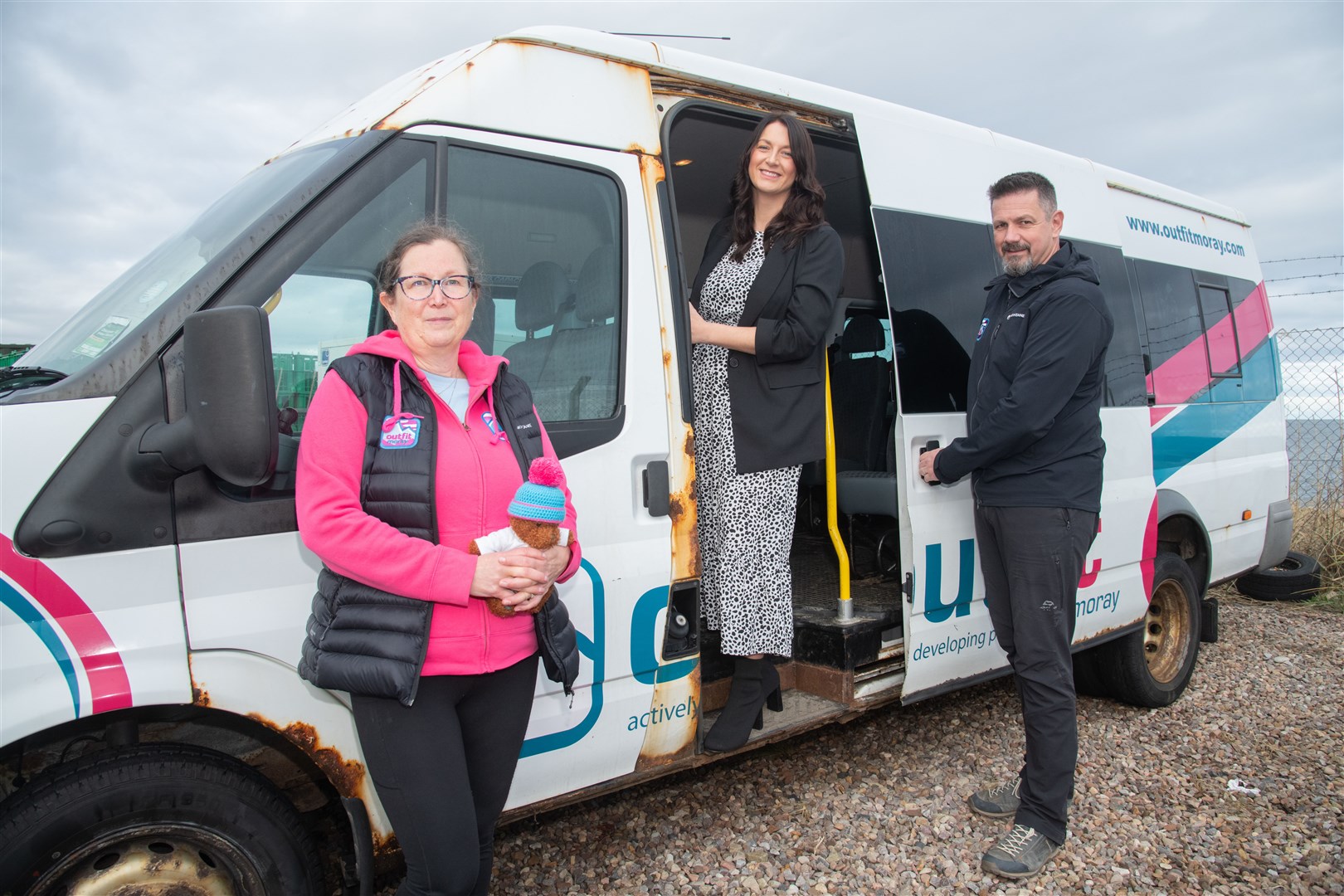 Karen Cox (left) and Tony Brown (right) from Outfit Moray, along with Moray Chamber of Commerce CEO Sarah Medcraf in one of the old minibuses that's set to be replaced. Picture: Daniel Forsyth.