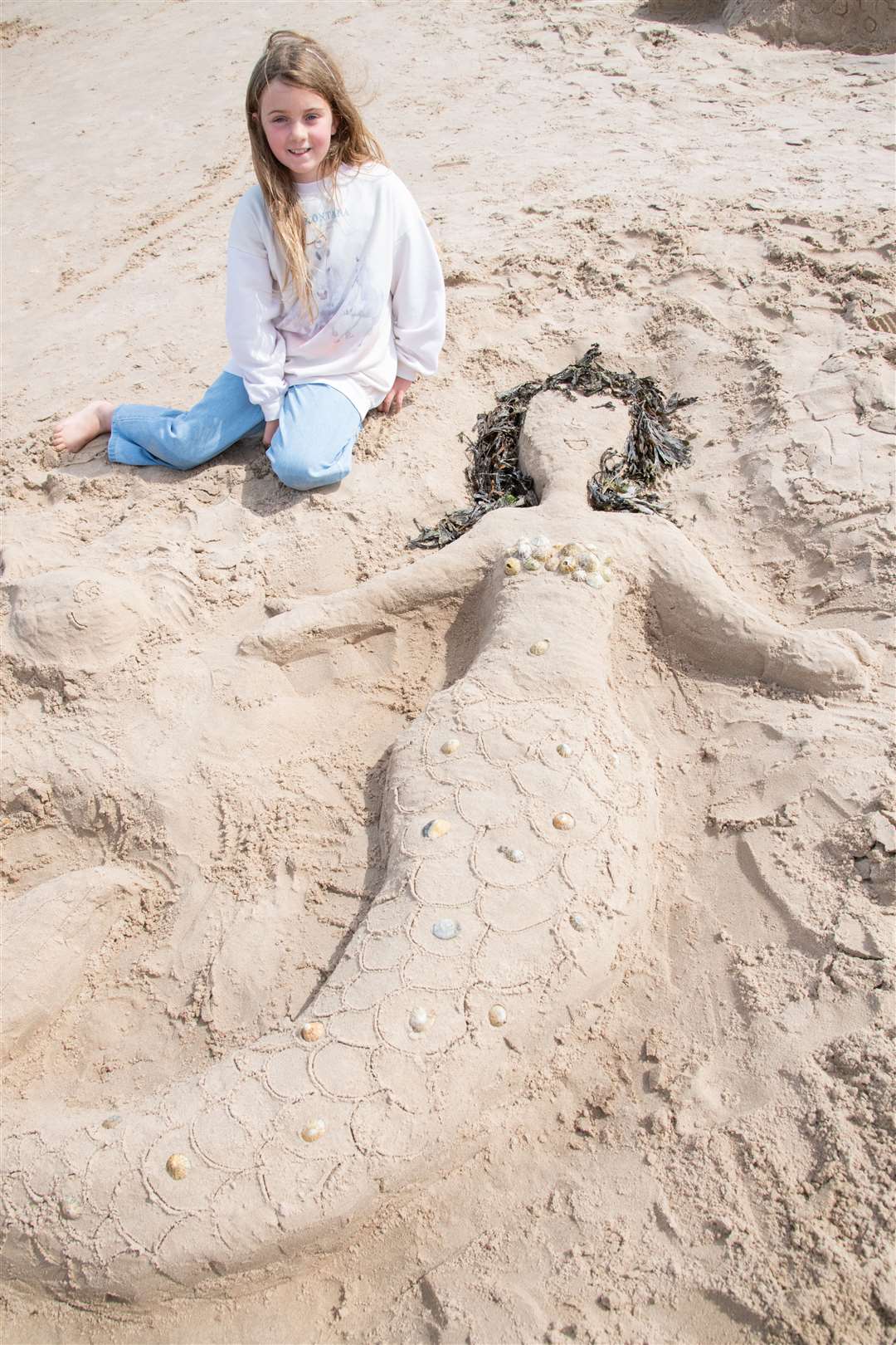 Alice May with her mermaid sculpture at the Sandcastle Competition. Picture: Daniel Forsyth