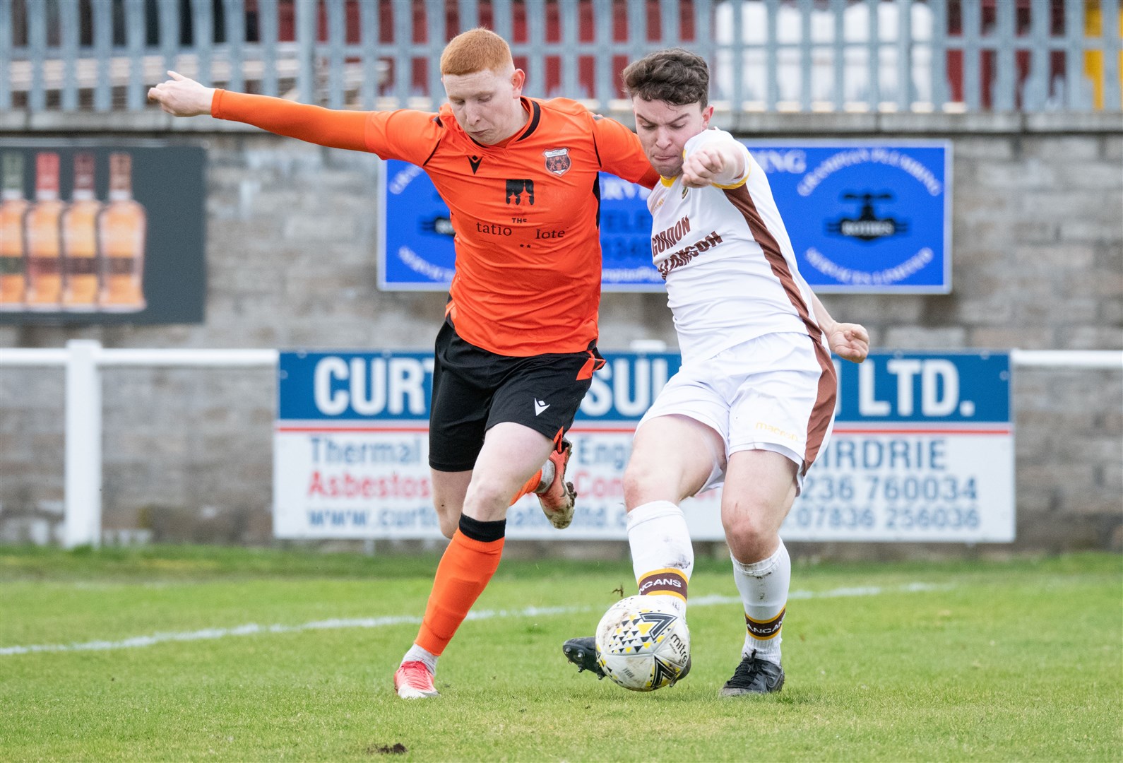 Forres' Ruari Fraser holds off a challenging Aidan Wilson of the home side...Rothes FC (2) vs Forres Mechanics FC (1) - Highland Football League 22/23 - Mackessack Park, Rothes 18/02/2023...(Picture: Daniel Forsyth..