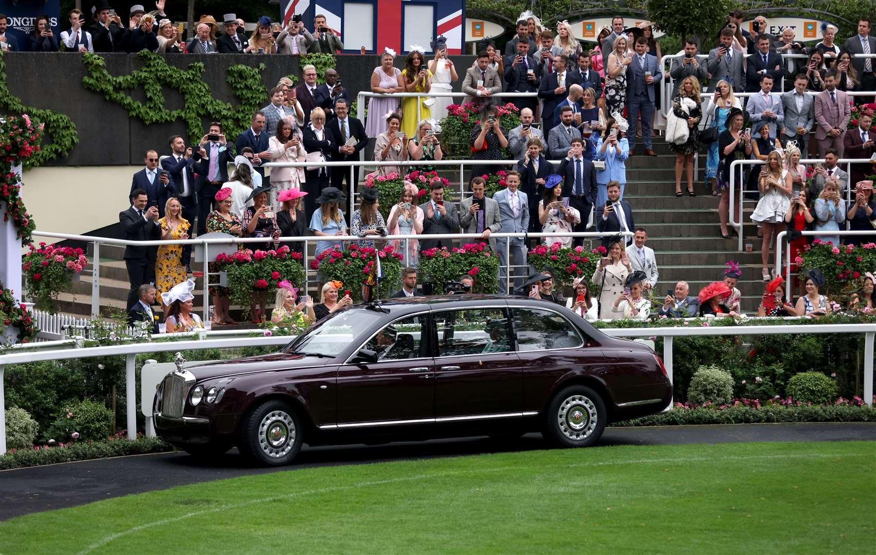 Racegoers applaud as the Queen arrives in the State Bentley Limousine (Steven Paston/PA)