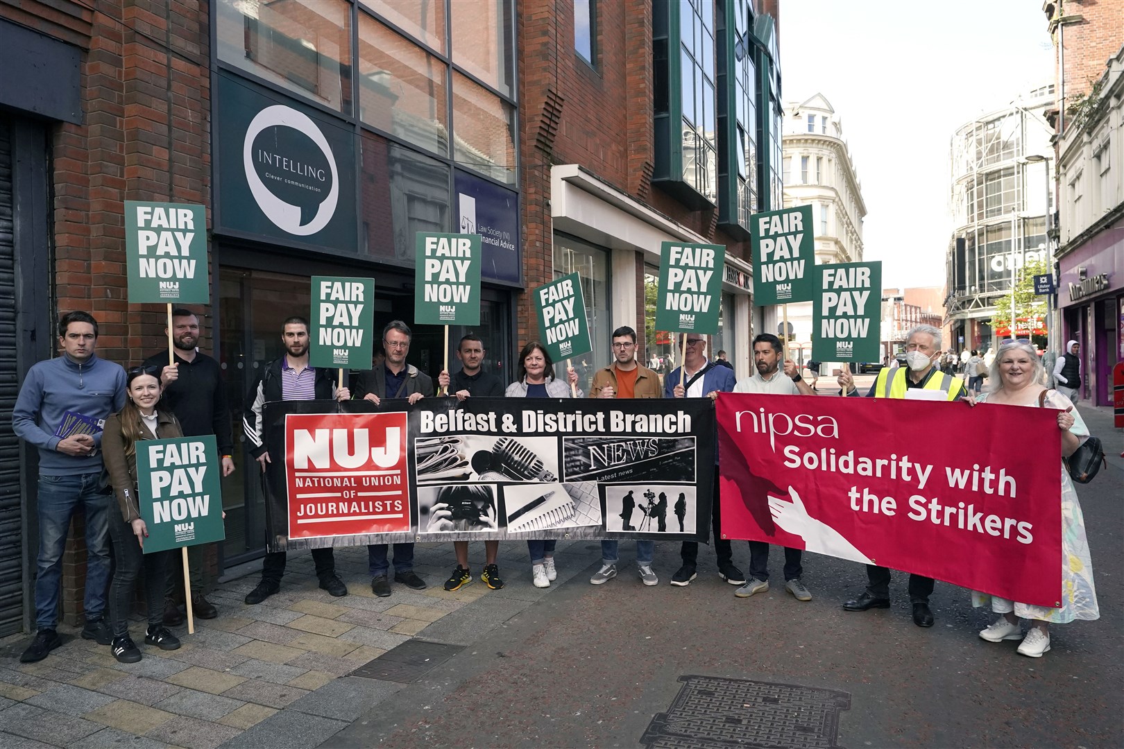 Members of Northern Ireland Public Service Alliance join members of the National Union of Journalists on the picket line outside the offices of Reach in Belfast (Niall Carson/PA)
