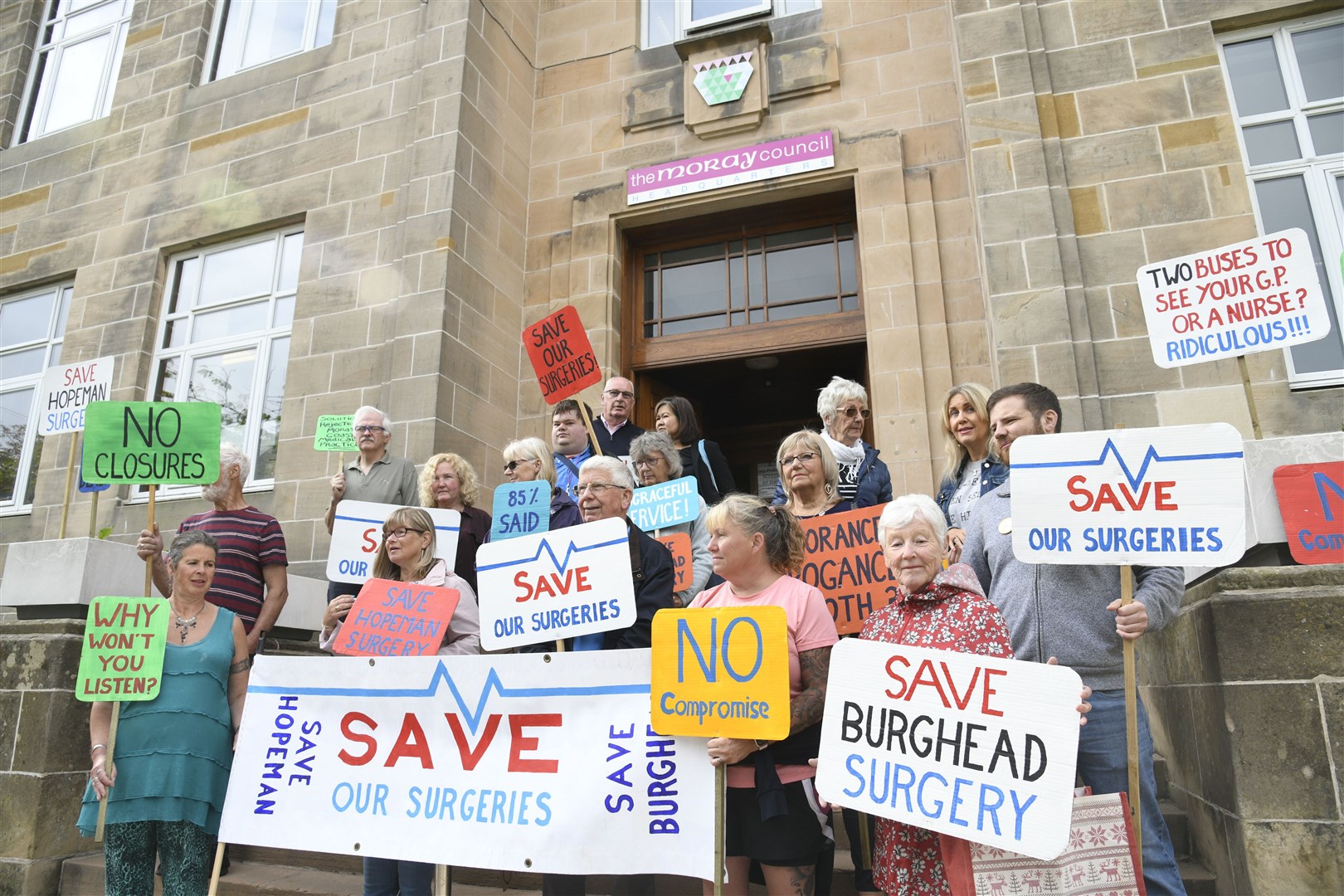 Demonstrators on the steps outside of Moray Council's headquarters. Picture: Daniel Forsyth